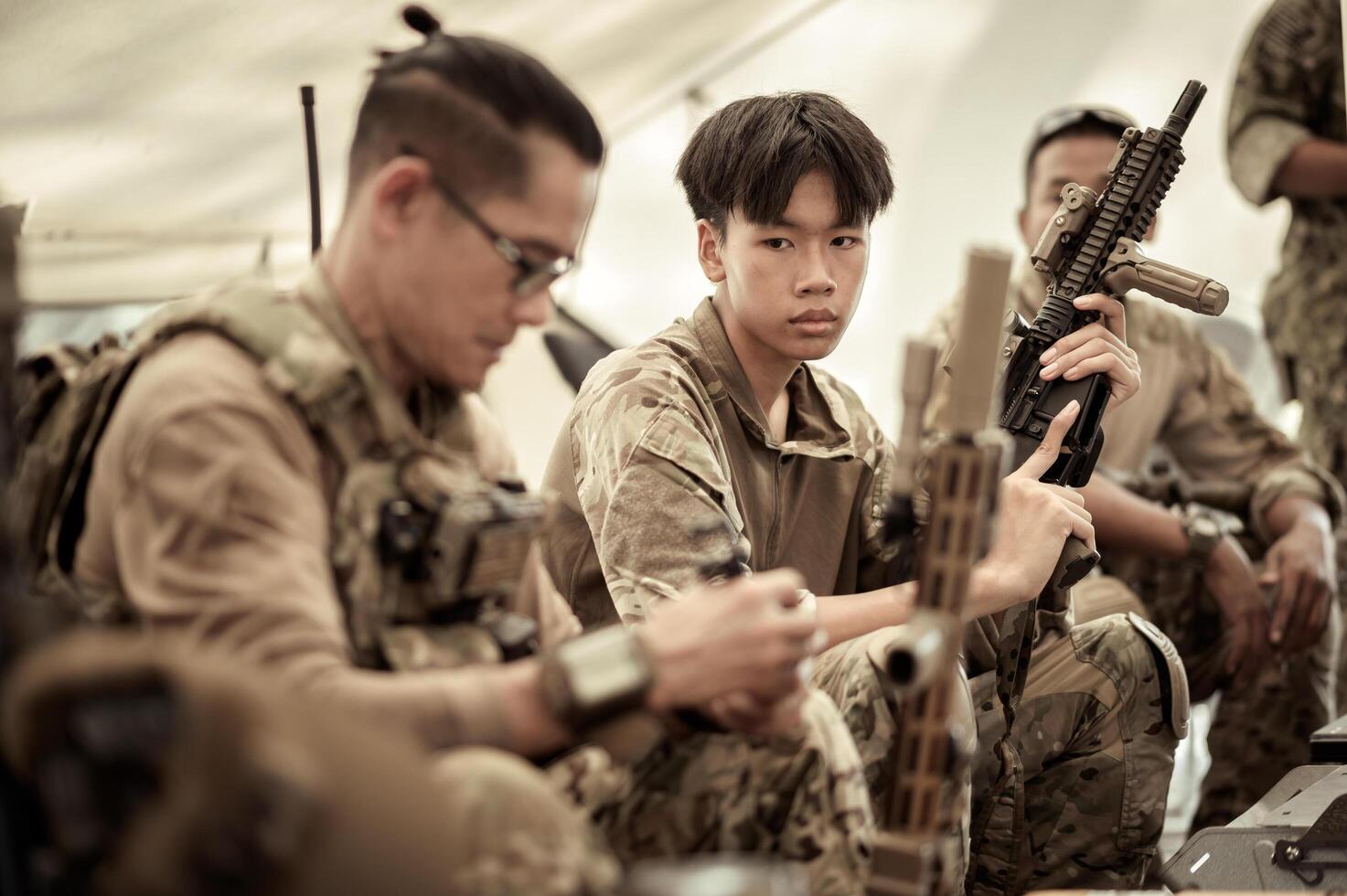 Soldiers in camouflage uniforms planning on operation in the camp, soldiers training in a military operation photo