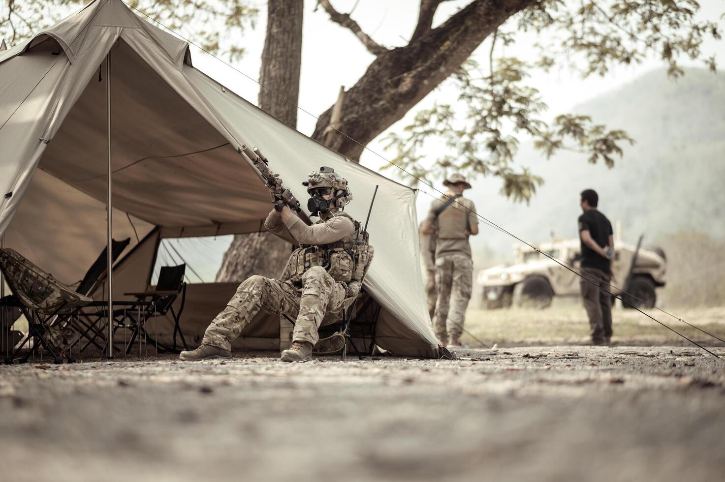 Soldiers in camouflage uniforms planning on operation in the camp, soldiers training in a military operation photo