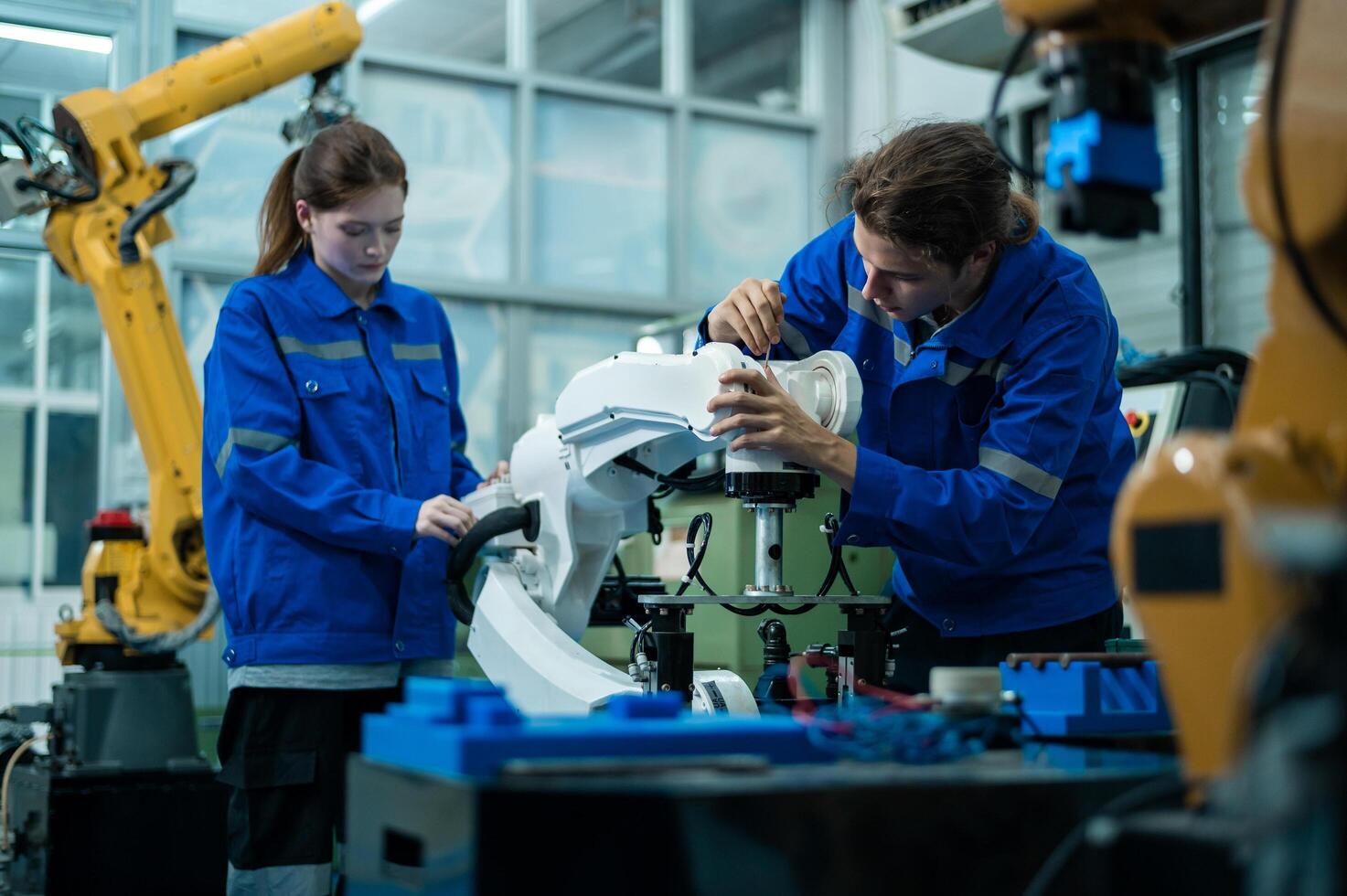 A group of Robotics engineers working with Programming and Manipulating Robot Hand, Industrial Robotics Design, High Tech Facility, Modern Machine Learning. Mass Production Automatics. photo