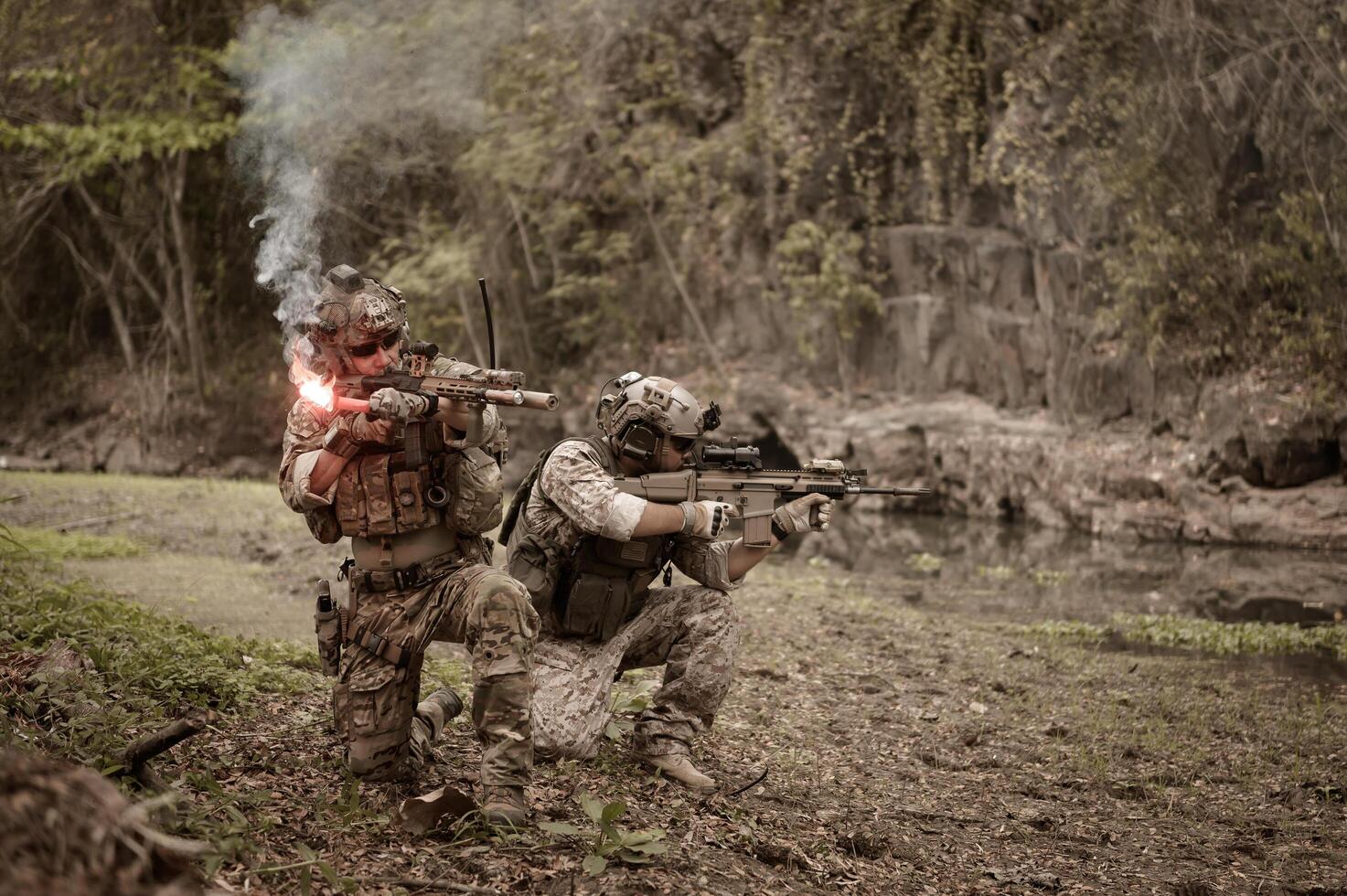 Soldiers in camouflage uniforms aiming with their riflesready to fire during Military Operation in the forest soldiers training in a military operation photo