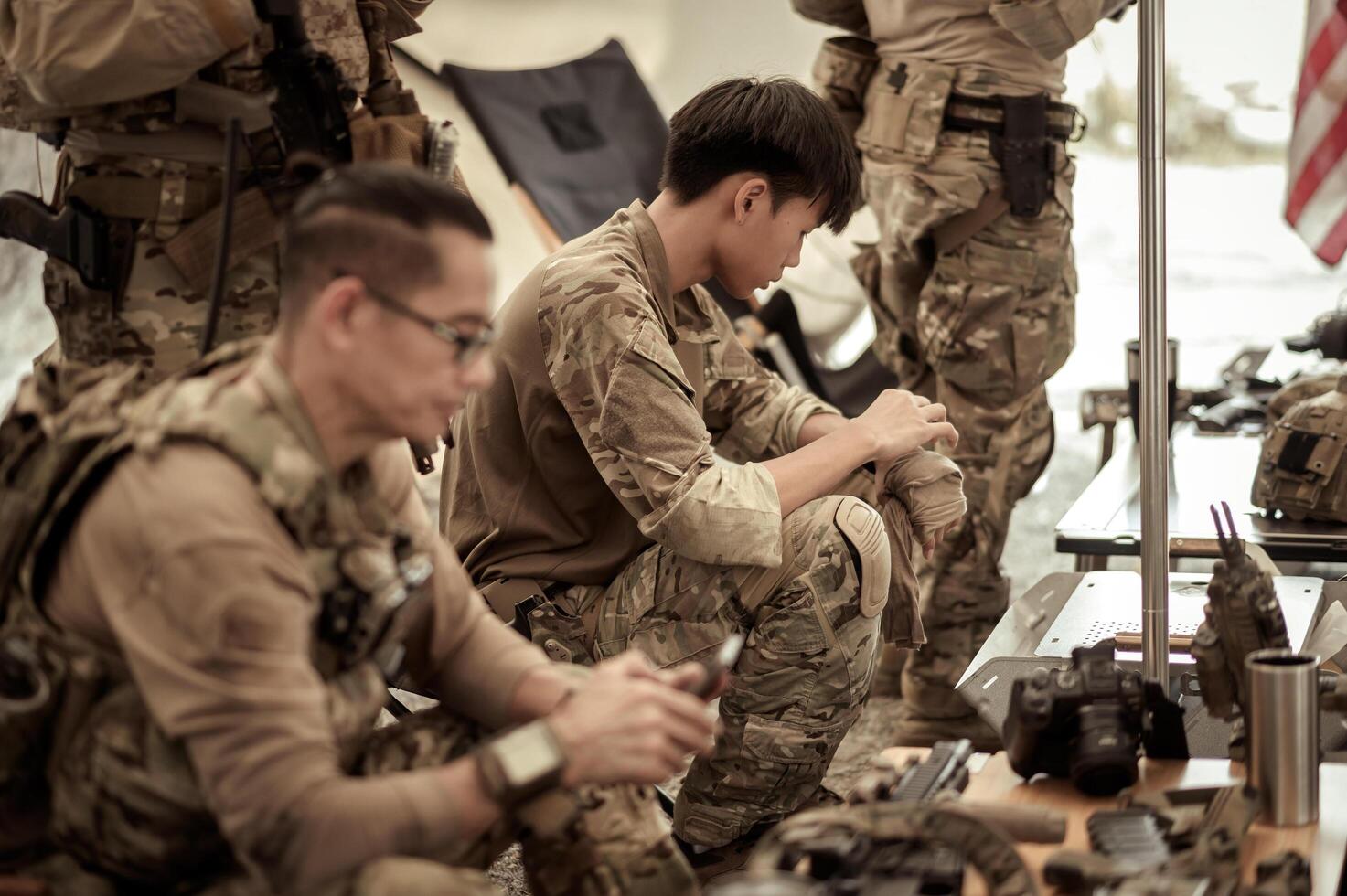 Soldiers in camouflage uniforms planning on operation in the camp, soldiers training in a military operation photo