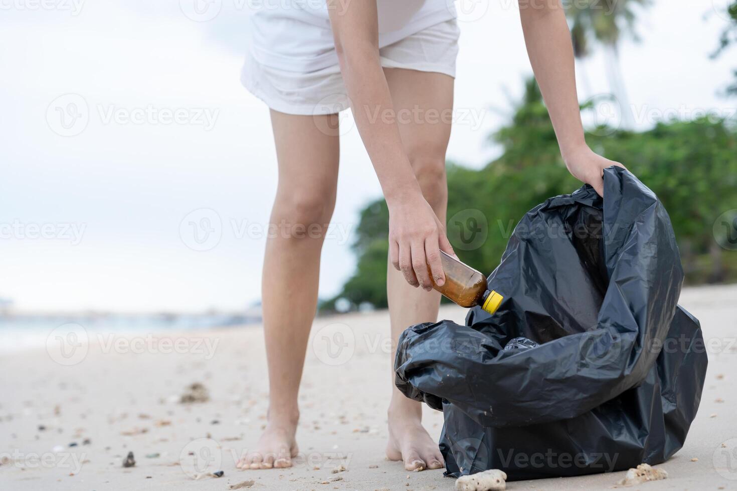 Save water. Volunteer pick up trash garbage at the beach and plastic bottles are difficult decompose prevent harm aquatic life. Earth, Environment, Greening planet, reduce global warming, Save world photo