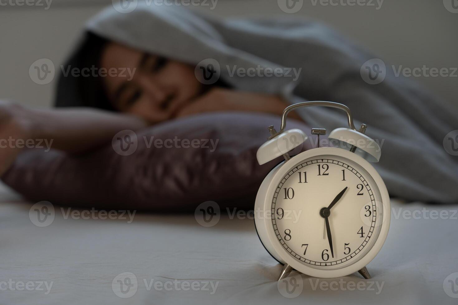 asian woman in bed late trying to sleep suffering insomnia, sleepless or scared in a nightmare, looking sad worried and stressed. Tired and headache or migraine waking up in the middle of the night. photo