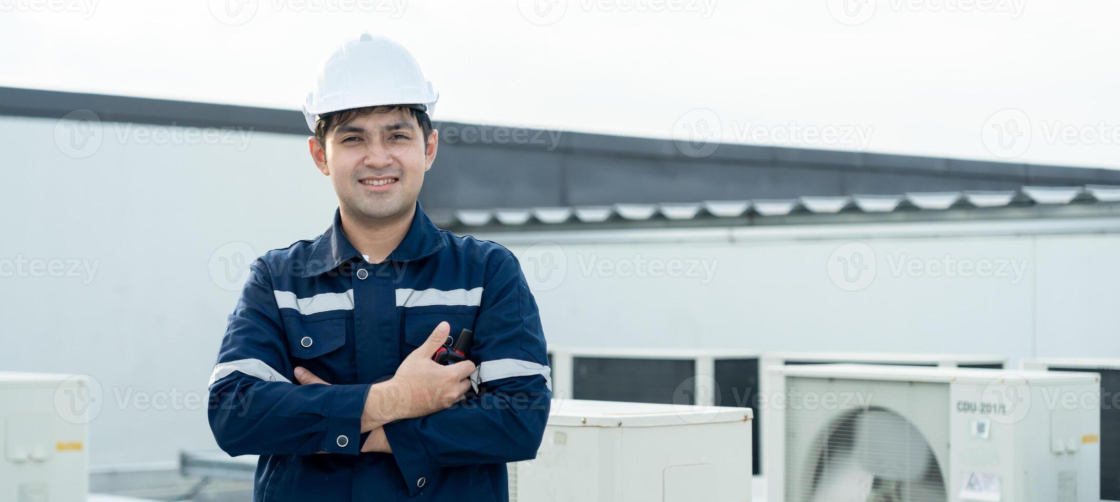 Portrait Asian maintenance engineer works on the roof of factory. contractor inspect compressor system and plans installation of air condition systems in construction, inspector, control photo