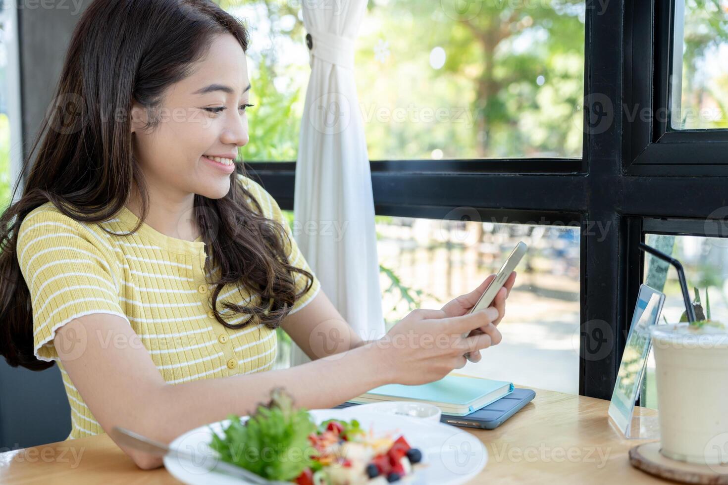 Woman use smartphone to scan QR code to pay in cafe restaurant with a digital payment without cash. Choose menu and order accumulate discount. E wallet, technology, pay online, credit card, bank app. photo