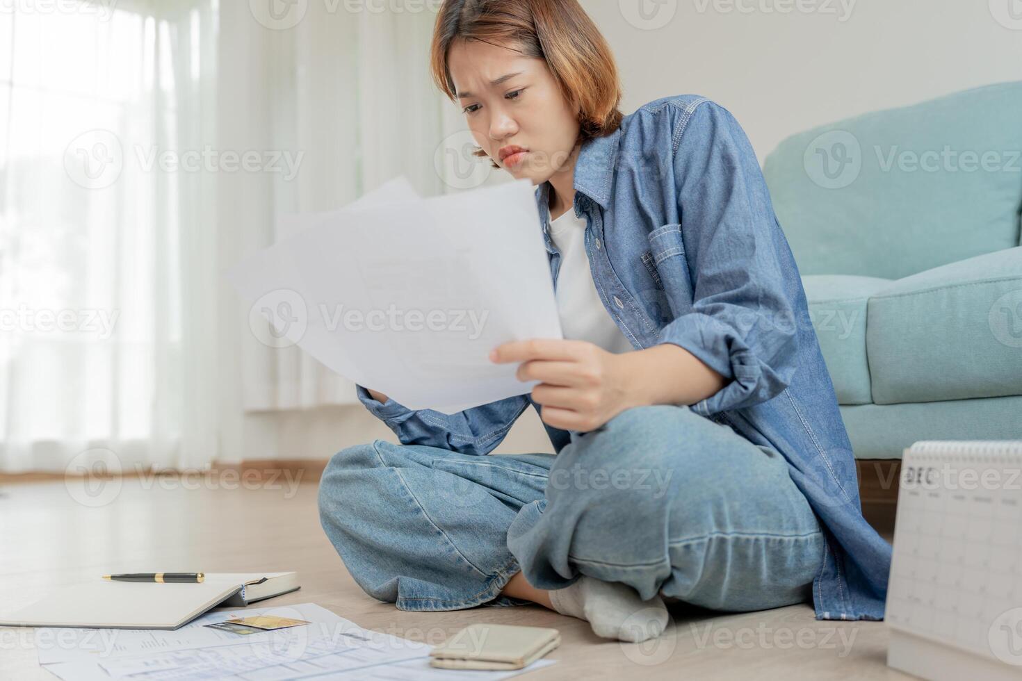 Stressed and headache asian woman with large bills or invoices no money to pay to expenses and credit card debt. shortage, Financial problems, mortgage, loan, bankruptcy, bankrupt, poor, empty wallet photo