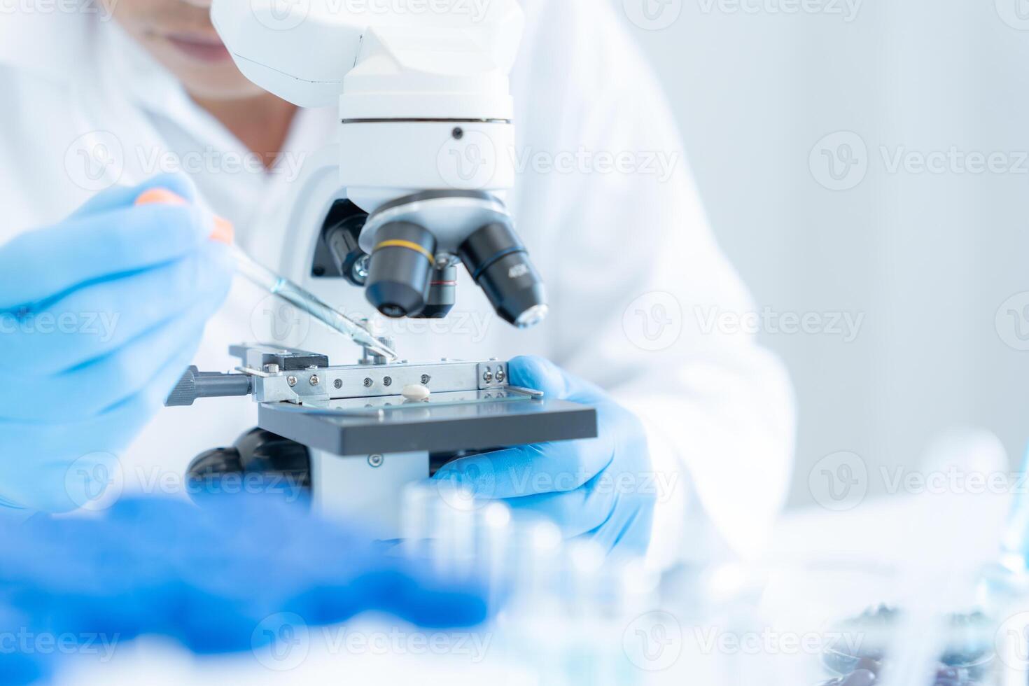 Scientist analyze biochemical samples in advanced scientific laboratory. Medical professional use microscope look microbiological developmental of viral. Biotechnology research in science lab. photo