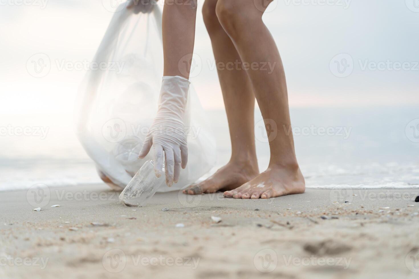 Save water. Volunteer pick up trash garbage at the beach and plastic bottles are difficult decompose prevent harm aquatic life. Earth, Environment, Greening planet, reduce global warming, Save world photo