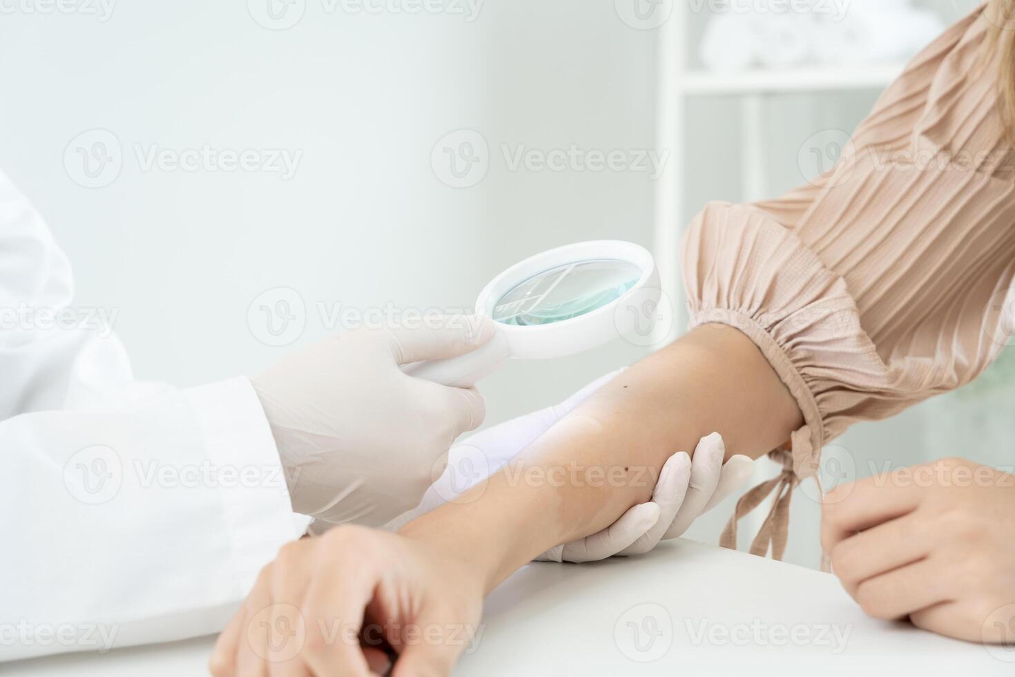 skin problem and beauty of asian girl. Dermatologist use magnifying glass look itchy skin from skin allergic, steroid allergy, sensitive skin, chemical allergy, rash, insect bites, Dermatitis. photo