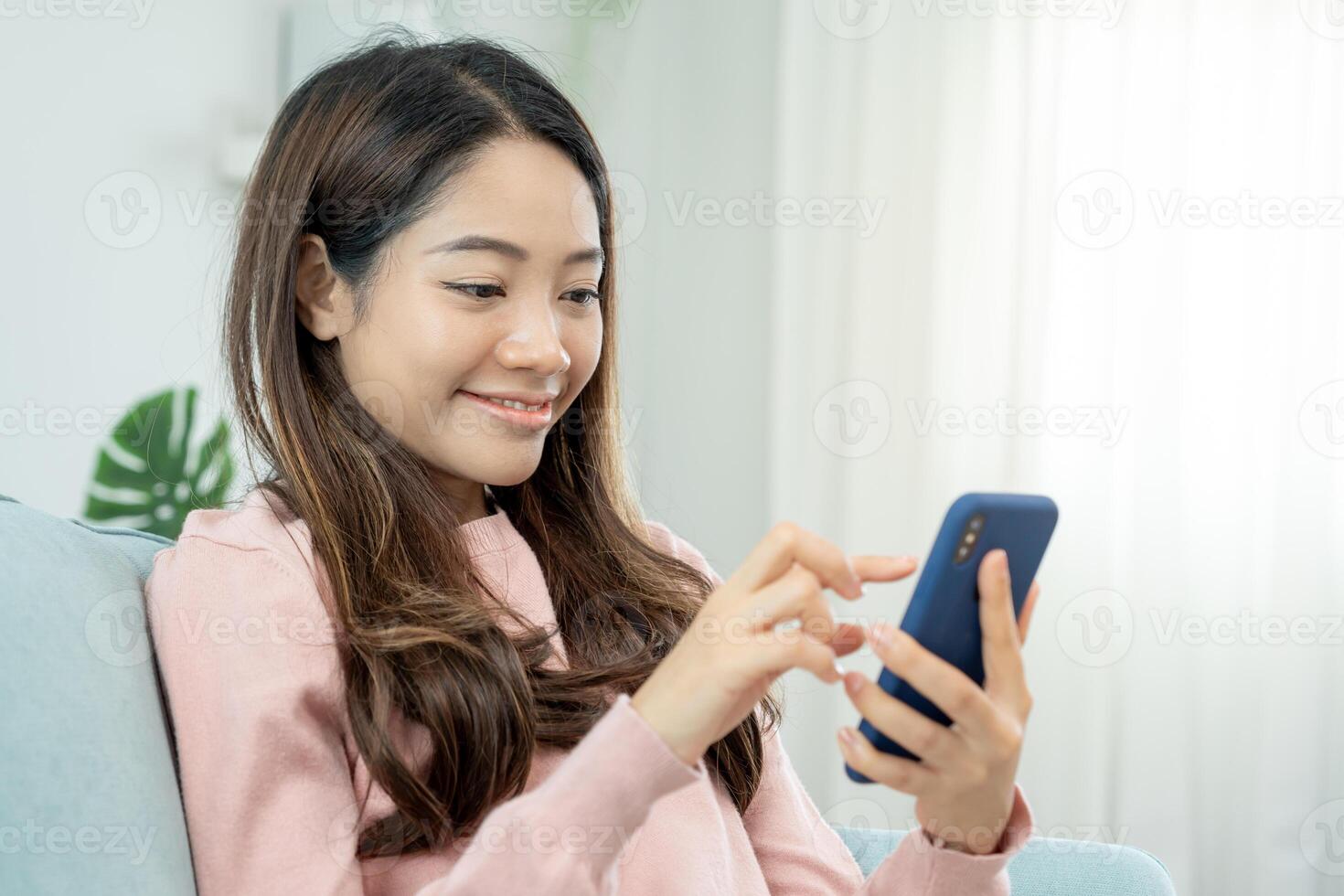 woman using smartphone for online shopping at home. Hand holding mobile phone with payment detail page display and credit card, stay home, technology, electronic commerce, internet, market place photo