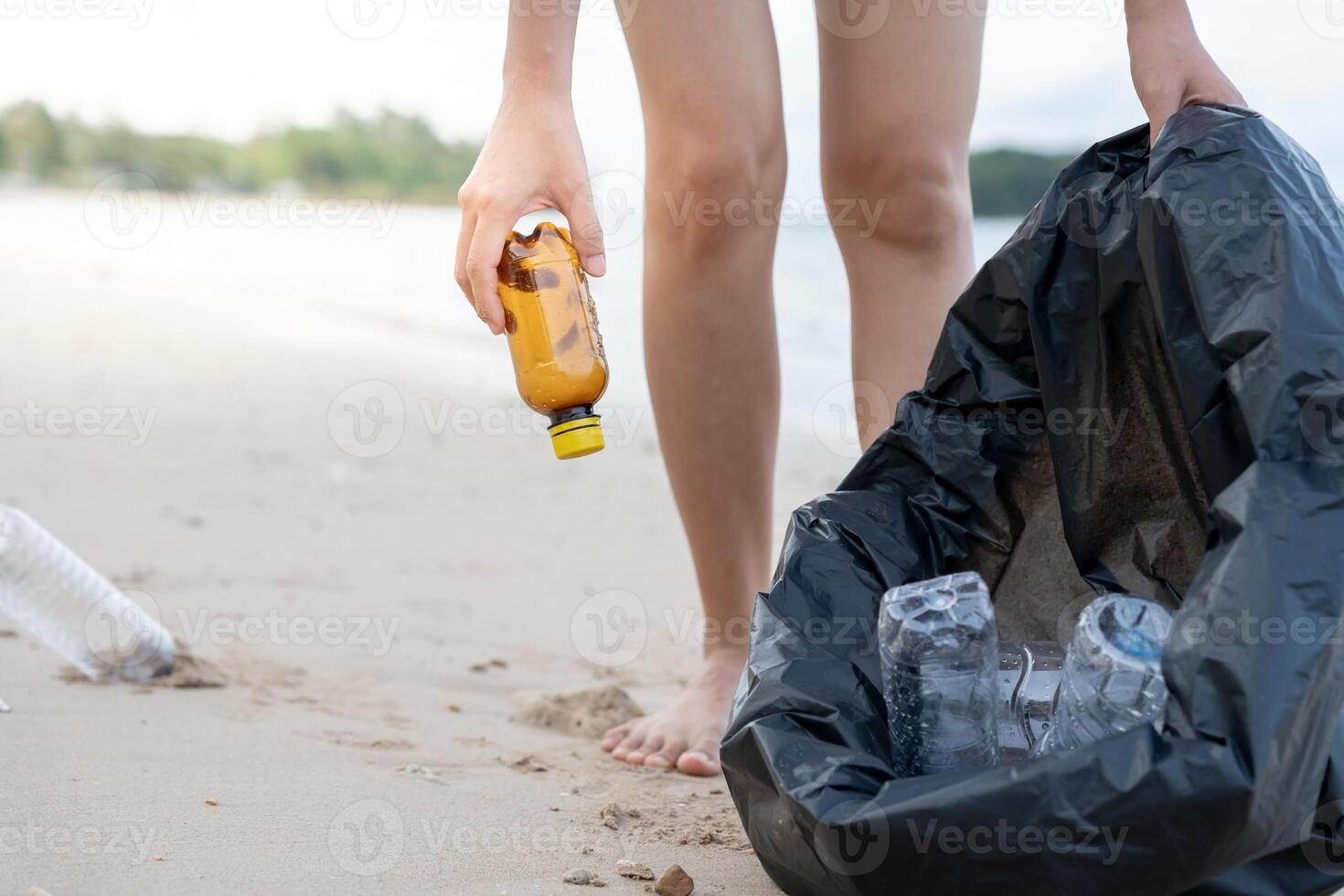 Save ocean. Volunteer pick up trash garbage at the beach and plastic bottles are difficult decompose prevent harm aquatic life. Earth, Environment, Greening planet, reduce global warming, Save world photo