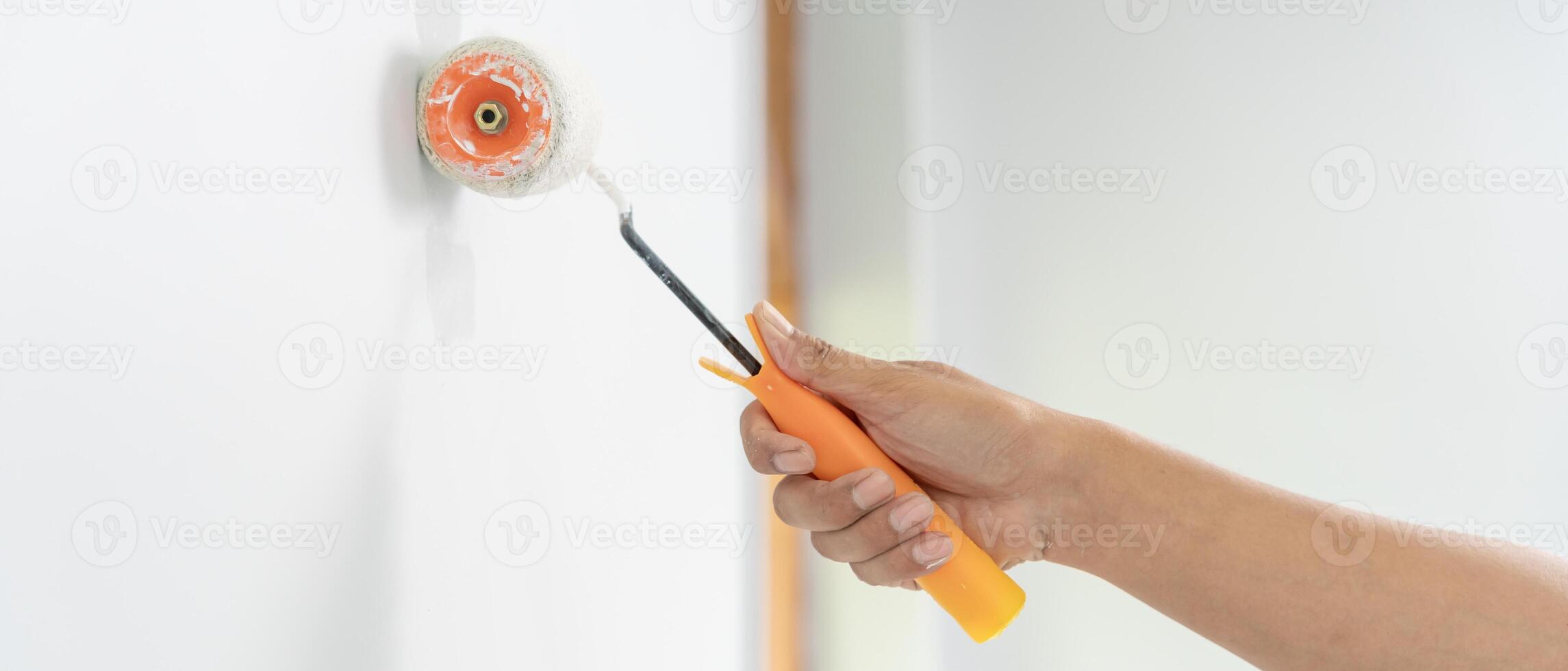 painter man, brush in hand for products to restore and paint the wall, indoor the building site of a house, wall during painting, renovation, painting, contractor, Architect, construction worker photo