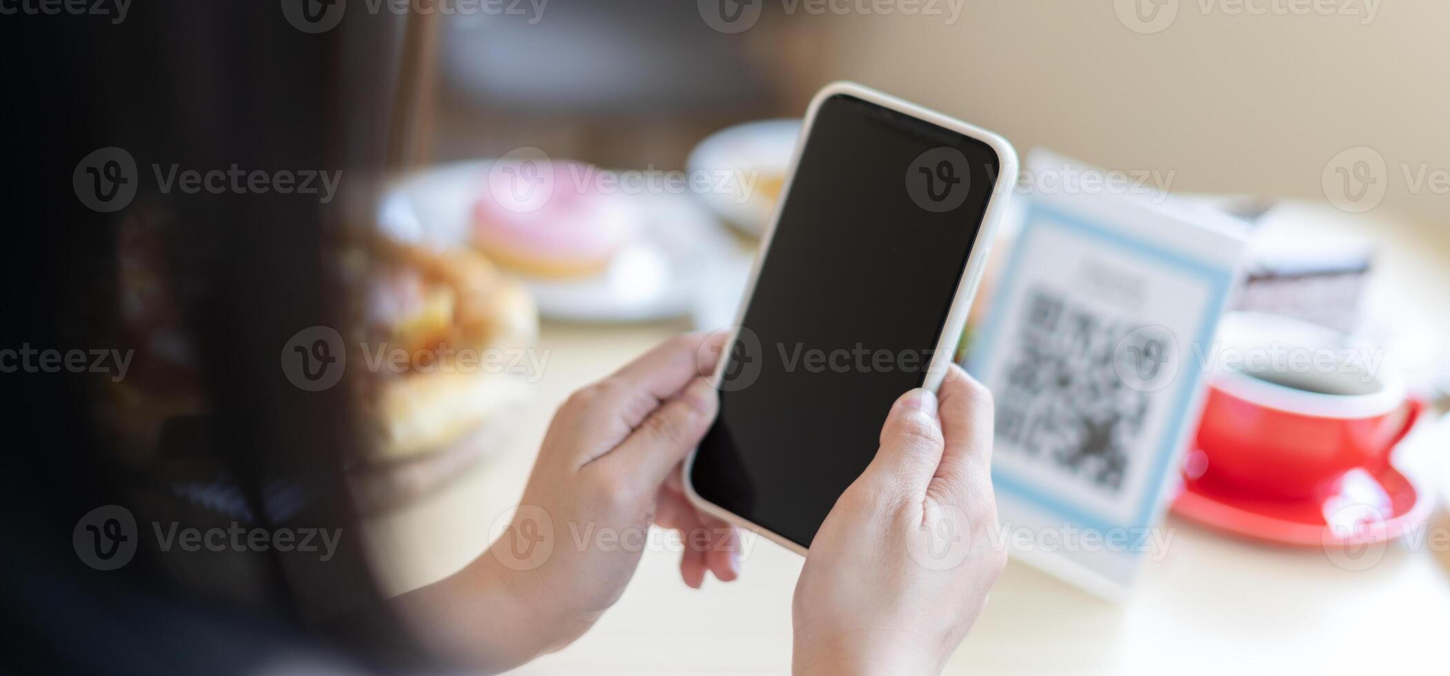 Woman use smartphone to scan QR code to pay in cafe restaurant with a digital payment without cash. Choose menu and order accumulate discount. E wallet, technology, pay online, credit card, bank app. photo