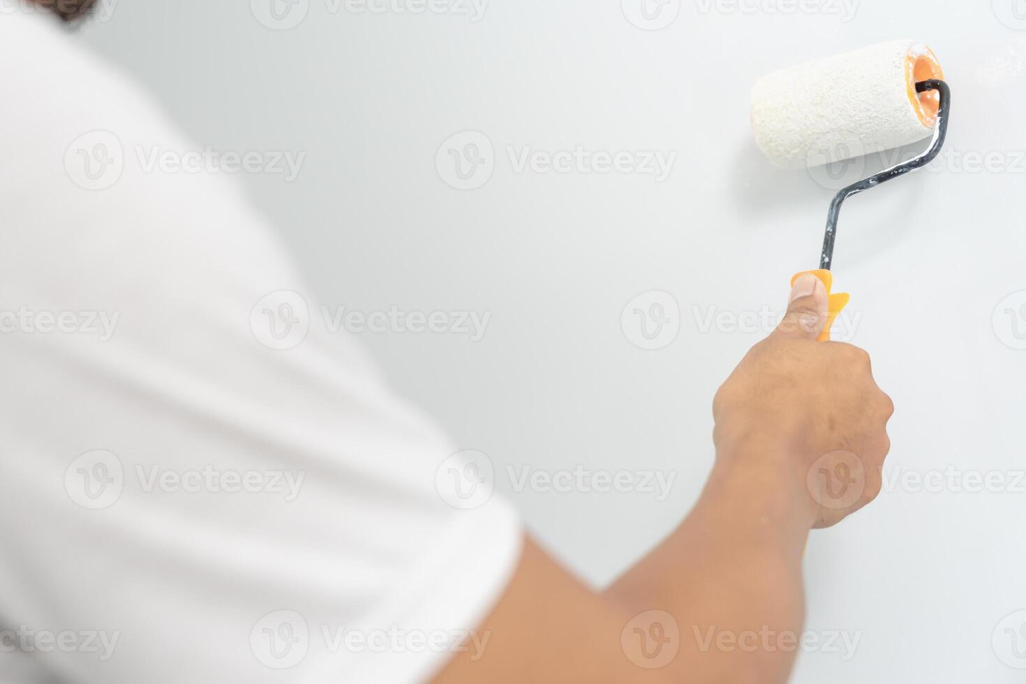 painter man, brush in hand for products to restore and paint the wall, indoor the building site of a house, wall during painting, renovation, painting, contractor, Architect, construction worker photo