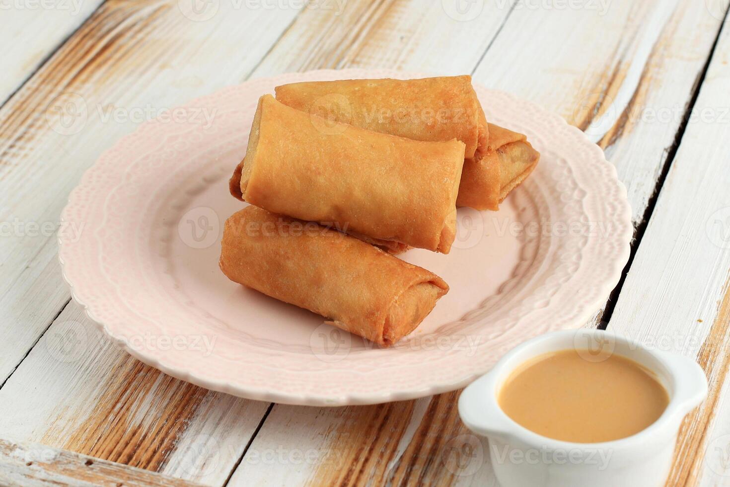 Lumpia or Popia Sayur is Spring Roll Filled with Fresh Vegetables. photo