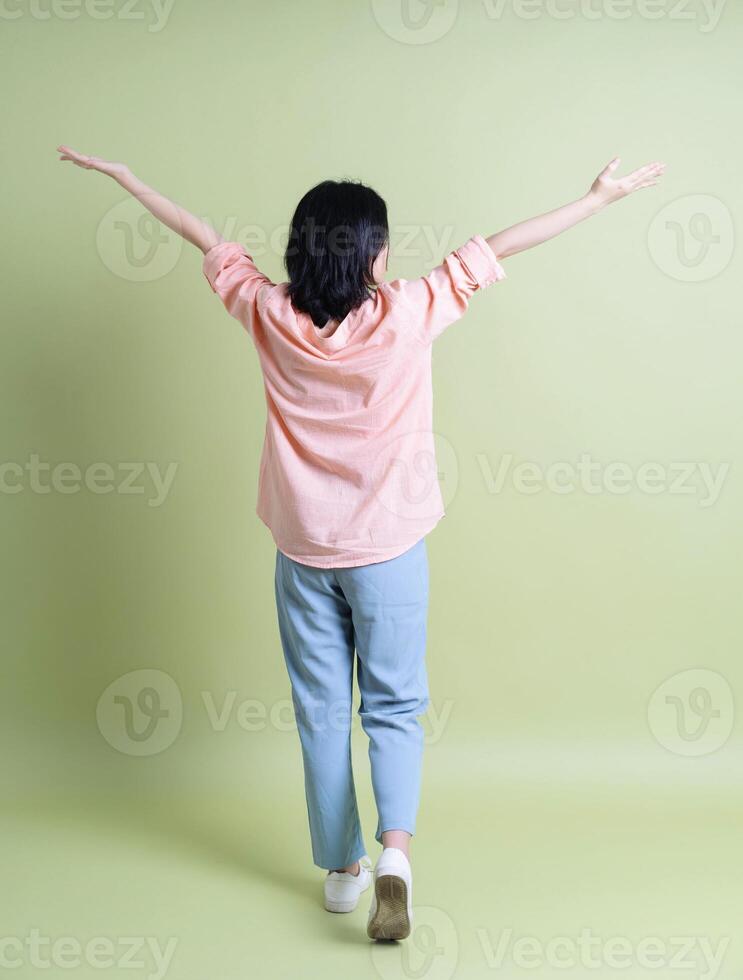 Photo of young Asian woman on background