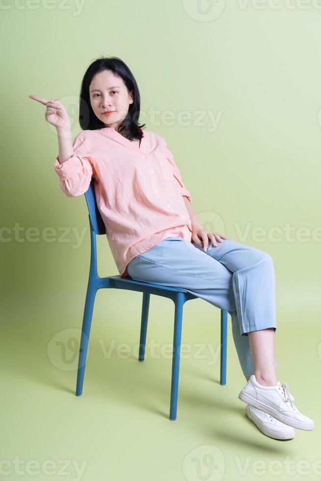 Photo of young Asian woman on background