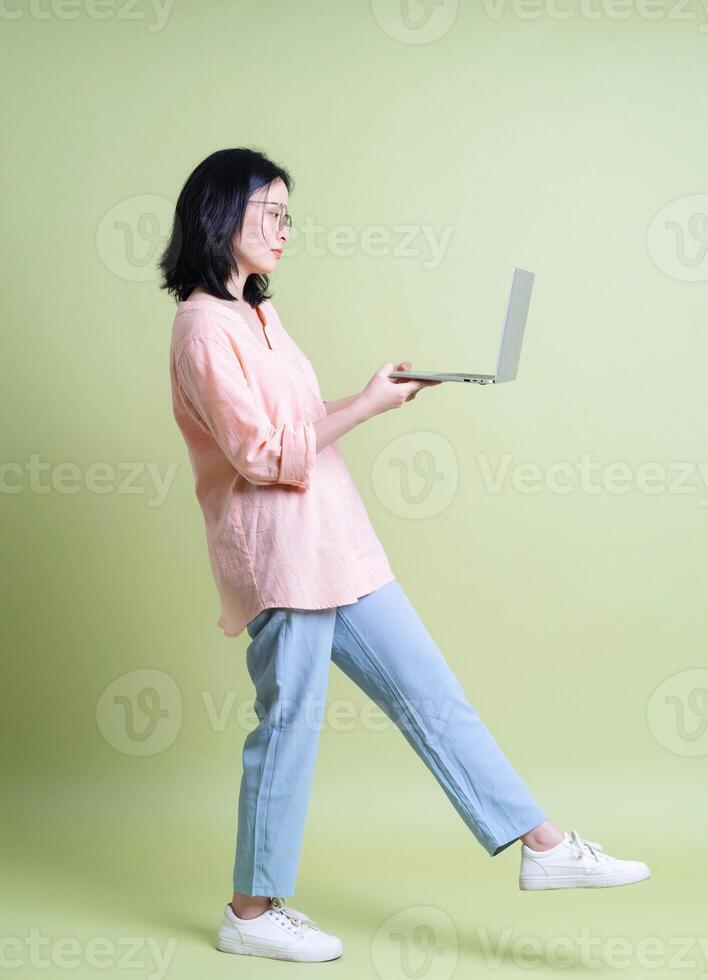 Photo of young Asian woman on background