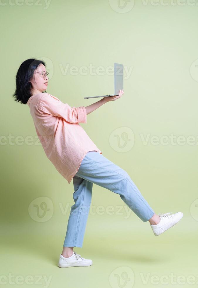 Photo of young Asian woman on background