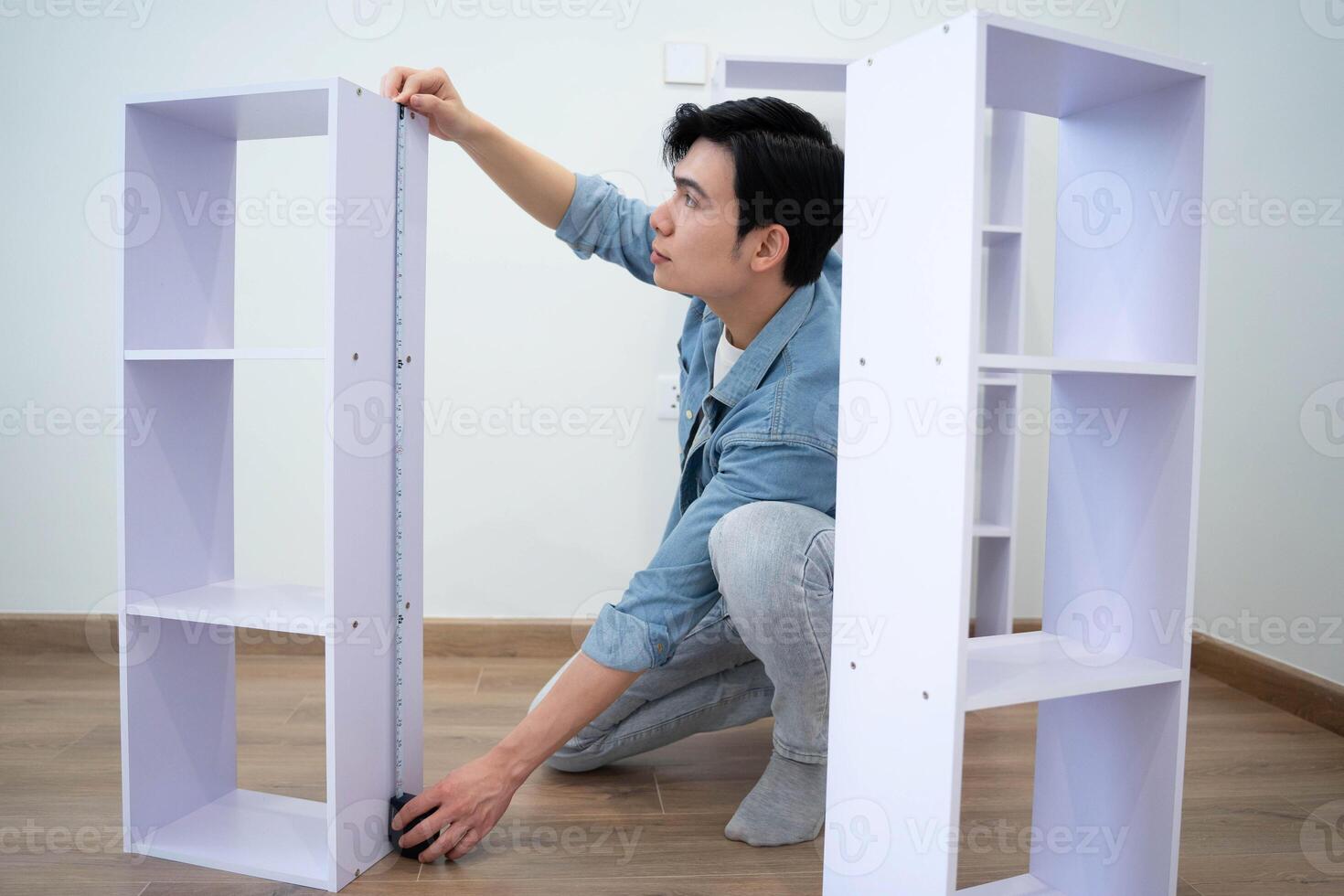 Asian man measuring and repairing houses photo