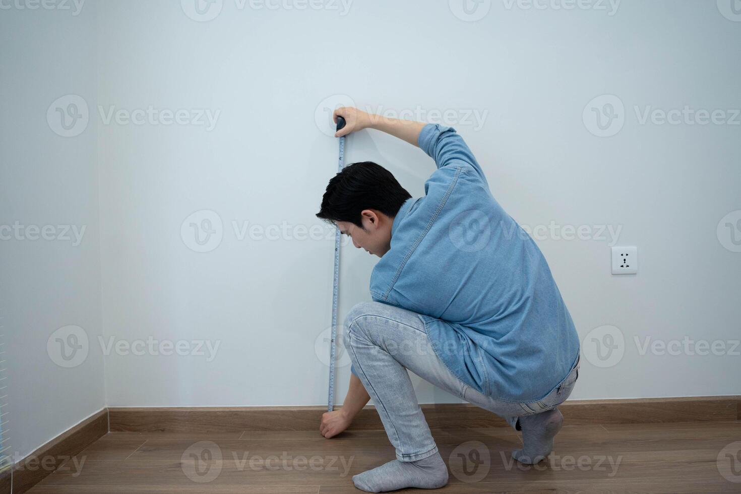 Asian man measuring and repairing houses photo