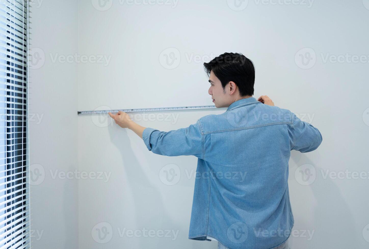 Asian man measuring and repairing houses photo