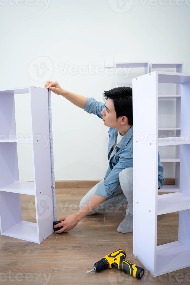 Asian man measuring and repairing houses photo