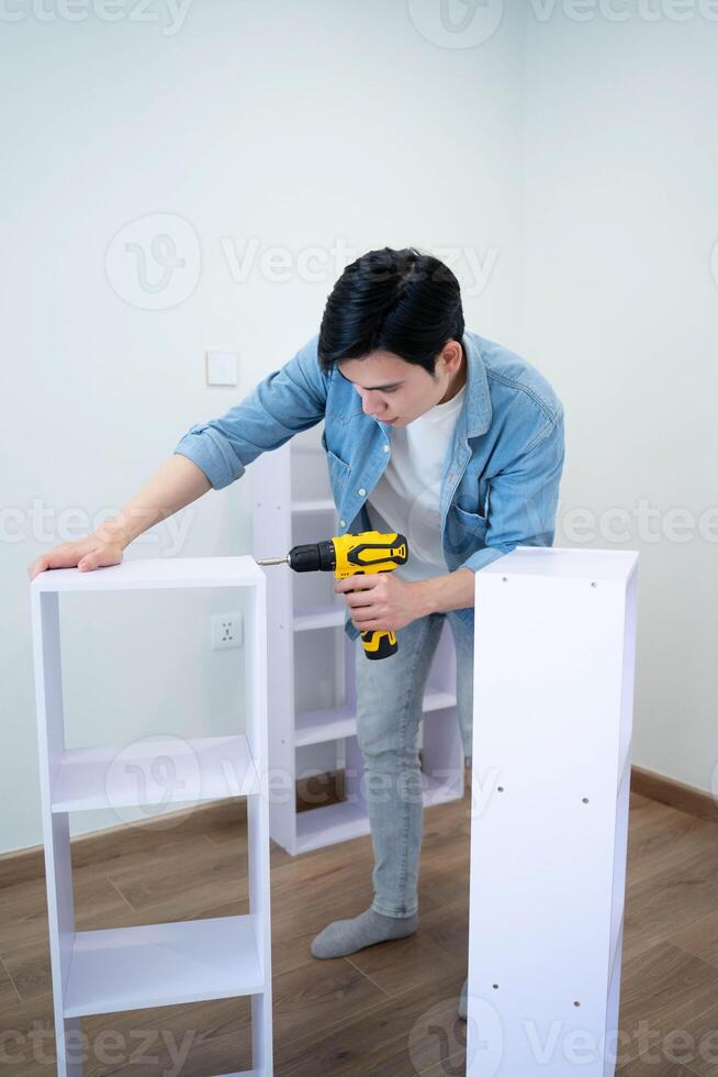 Asian man measuring and repairing houses photo