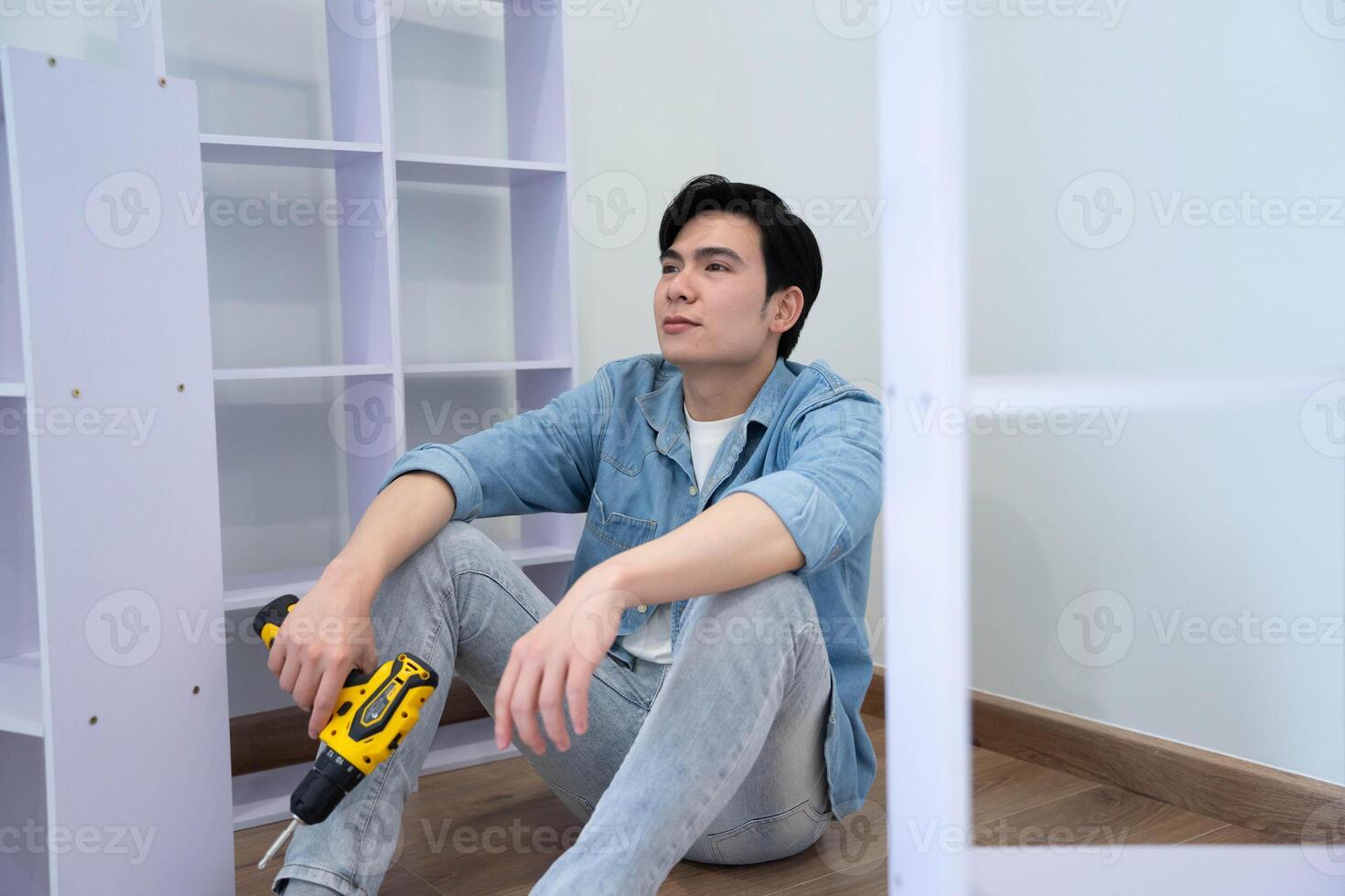 Asian man measuring and repairing houses photo