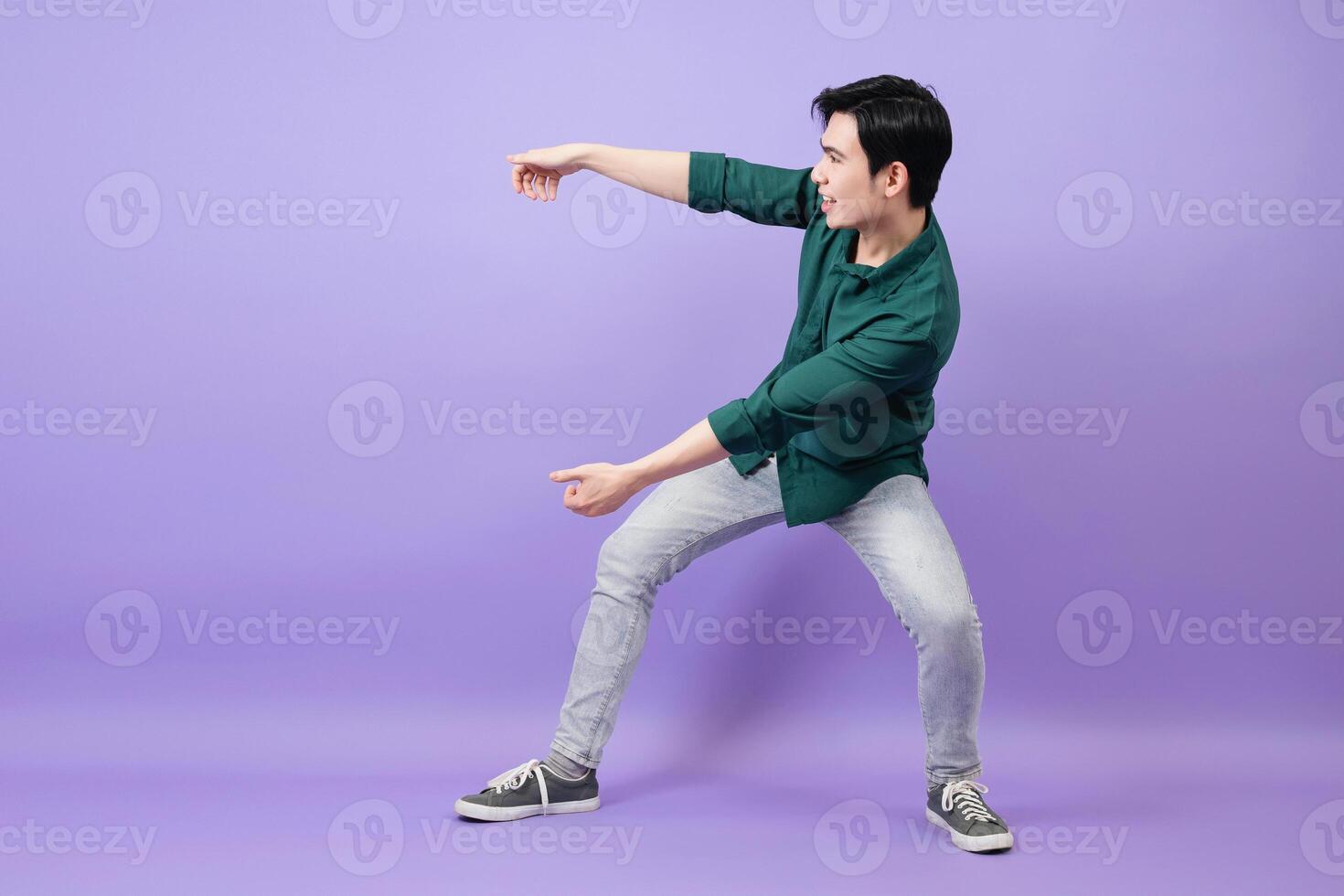 Young Asian businessman on purple background photo