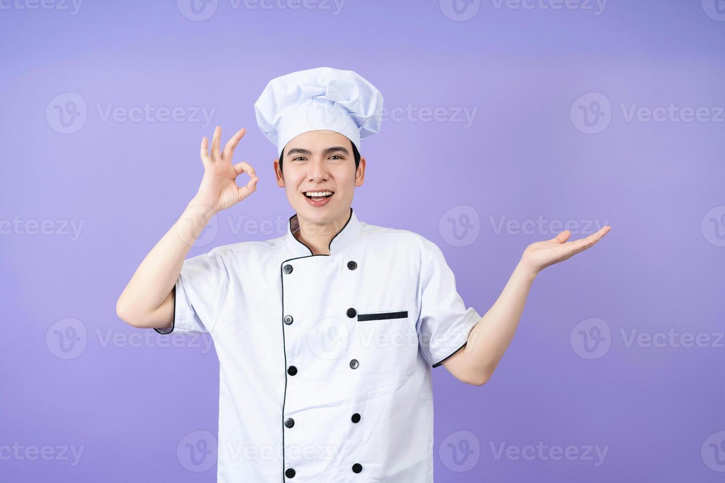 Young Asian male chef on background photo