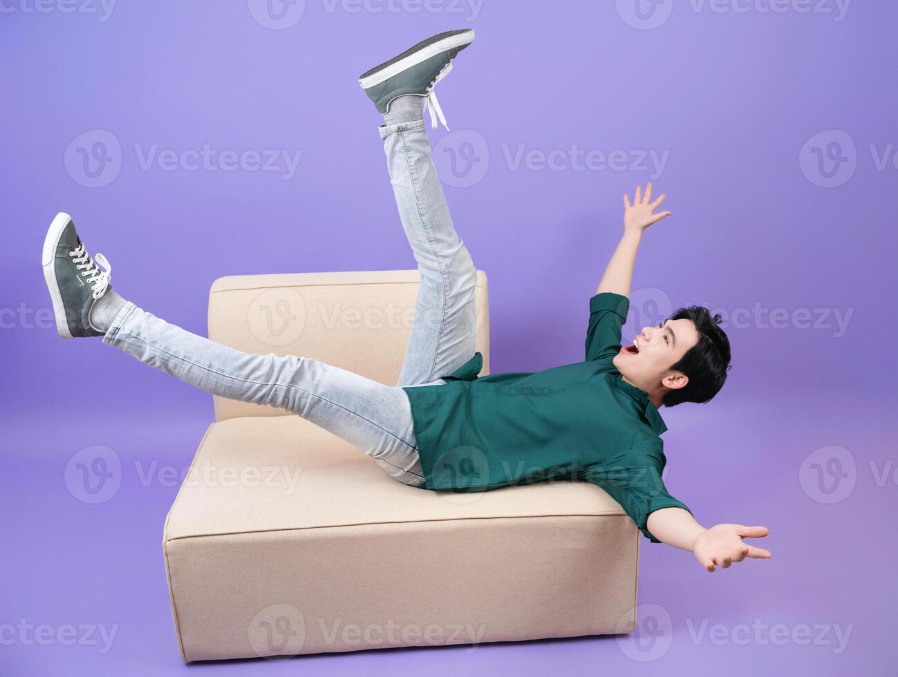 Young Asian businessman on purple background photo