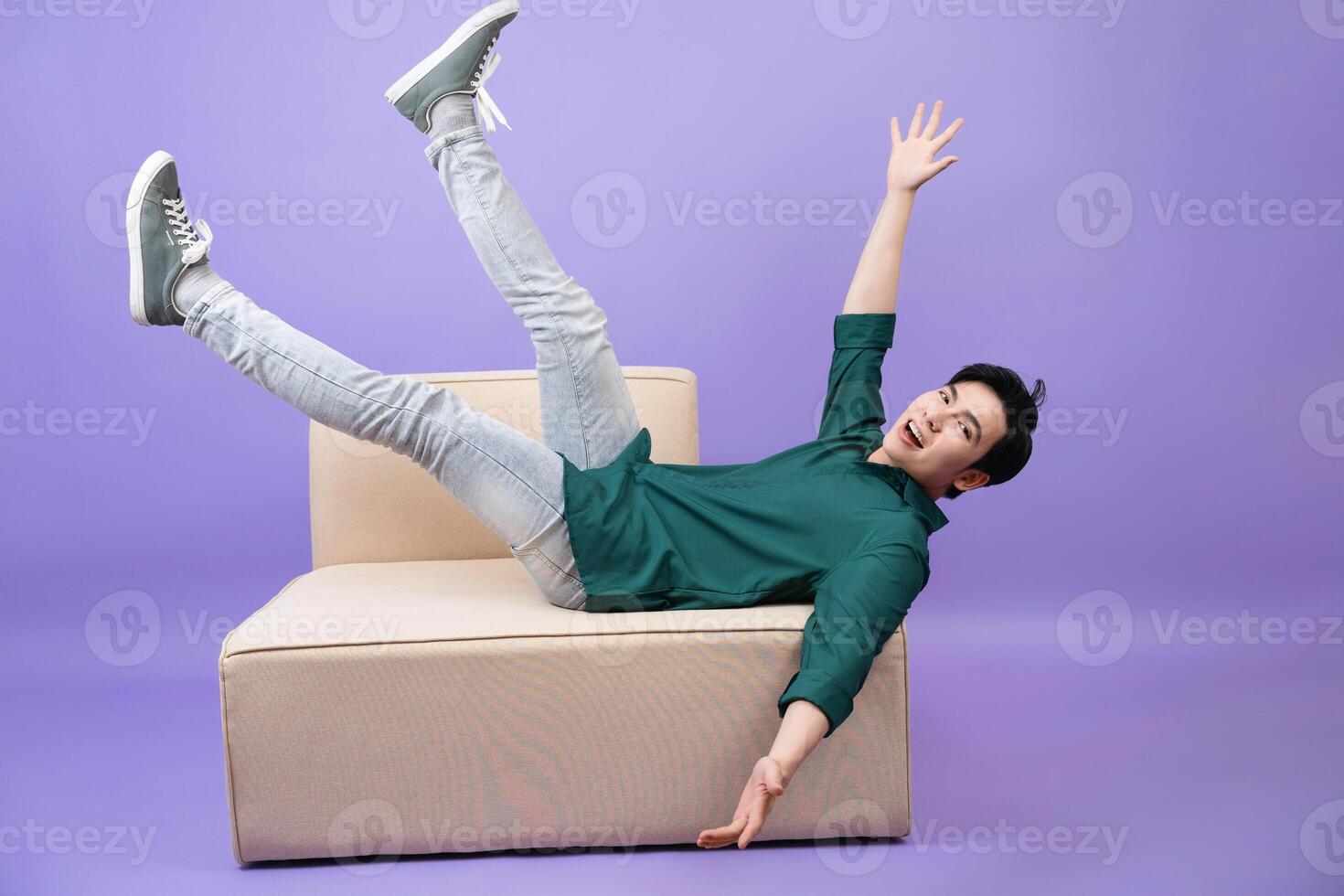 Young Asian businessman on purple background photo