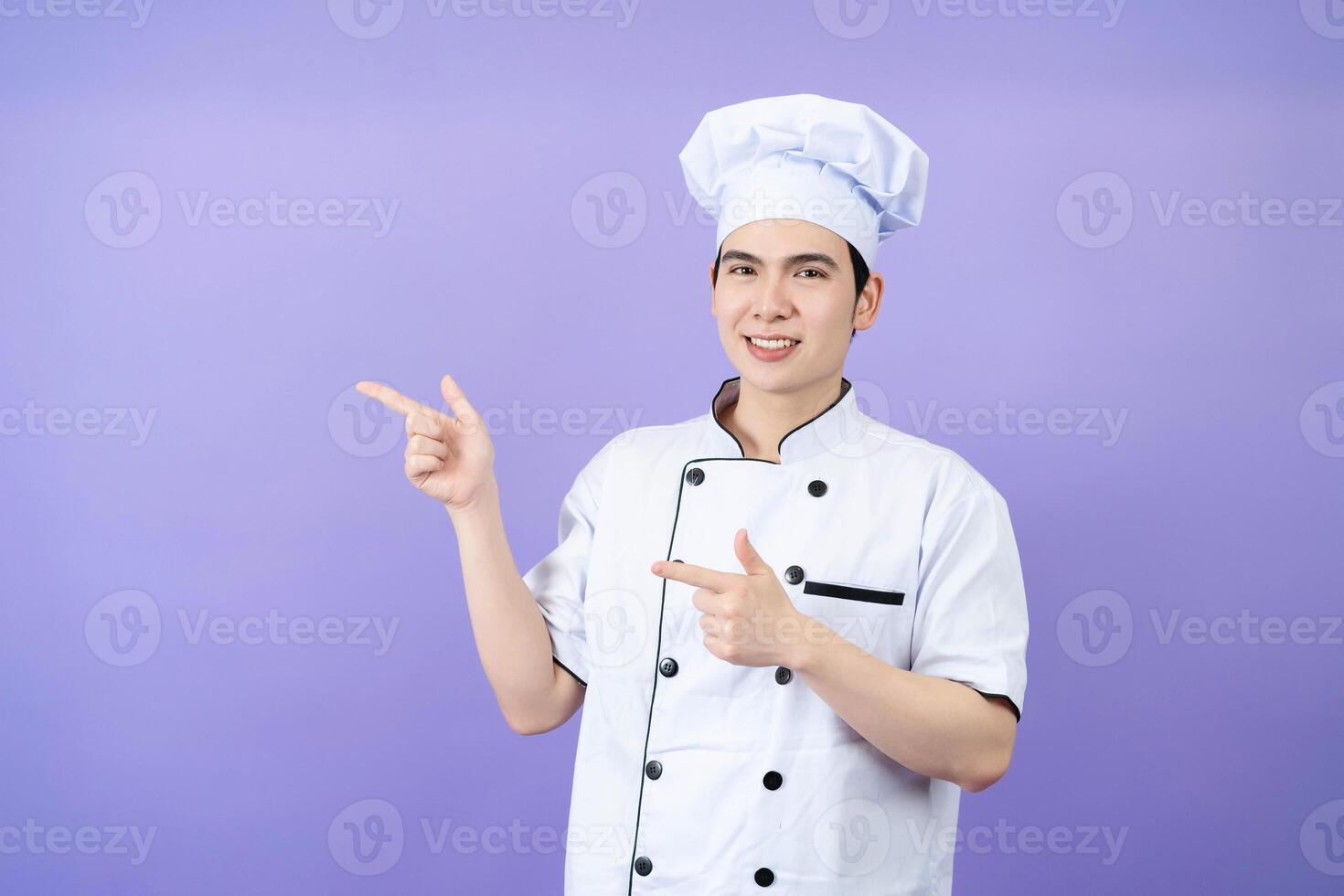 Young Asian male chef on background photo