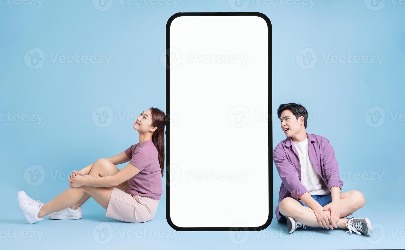 Young Asian couple on blue background photo