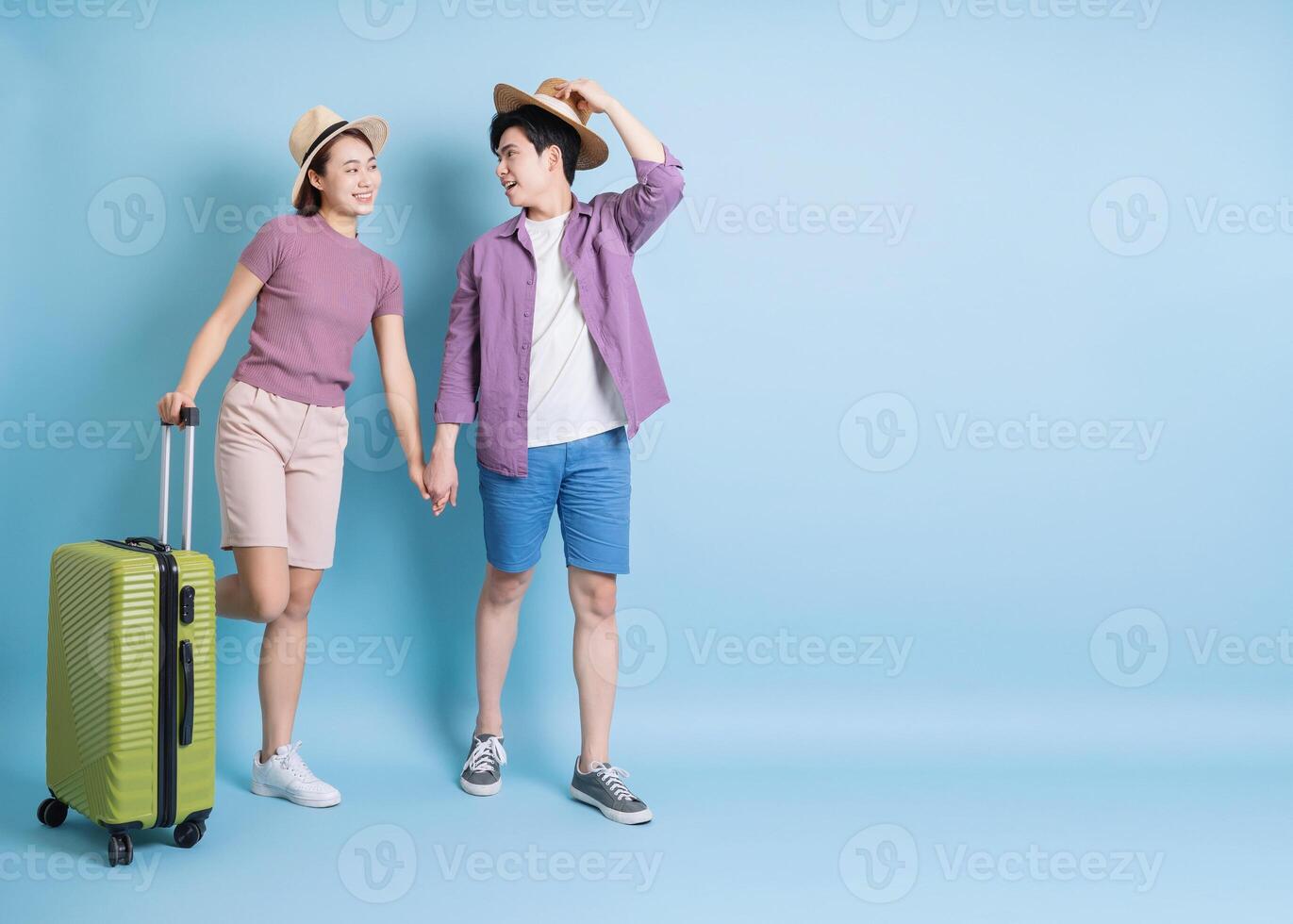 Young Asian couple on blue background photo