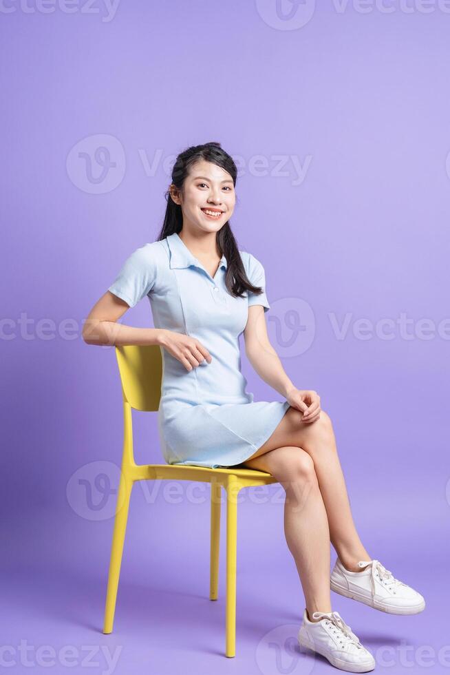 Photo of young Asian girl on purple background