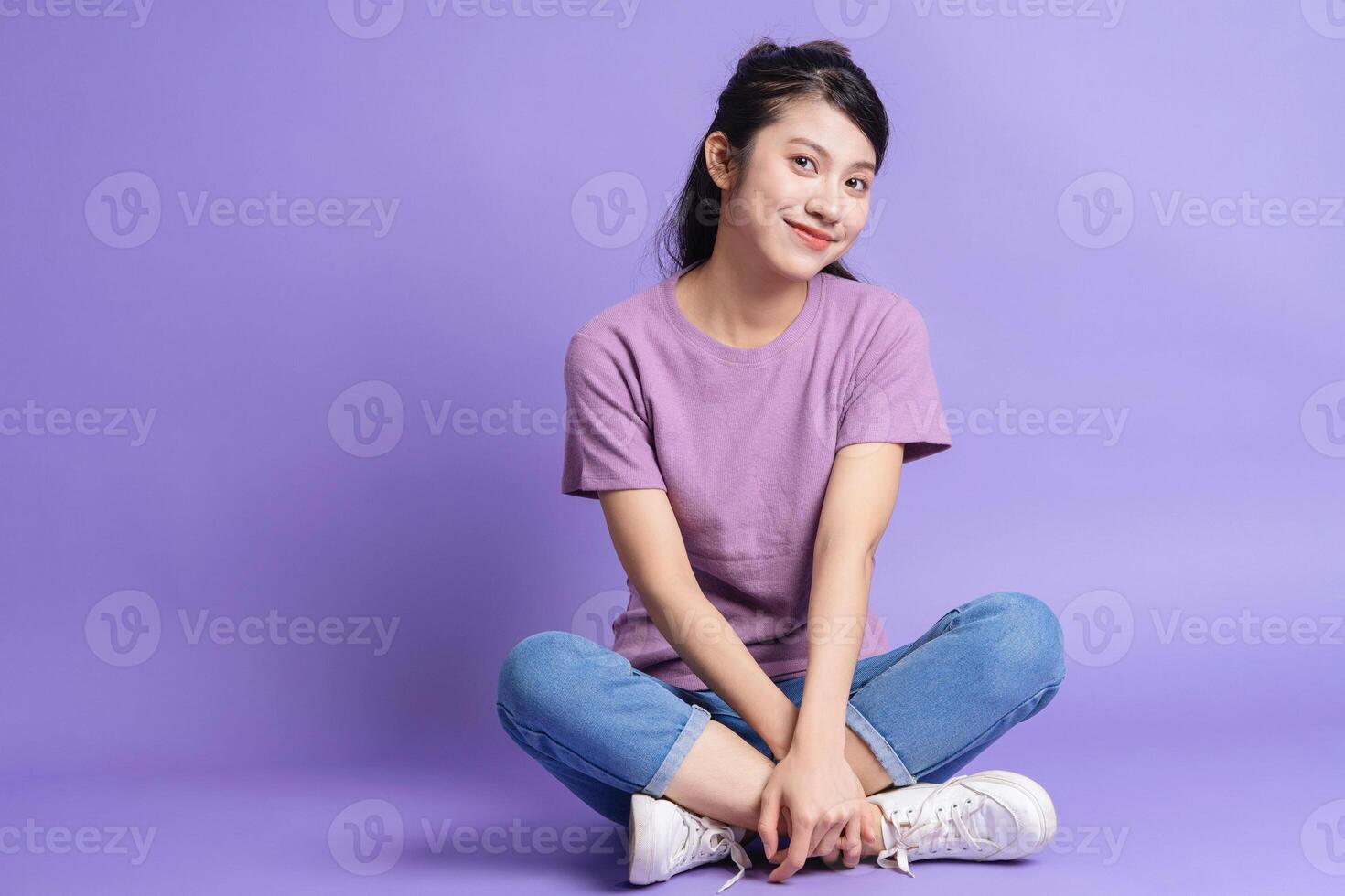 Photo of young Asian girl on purple background