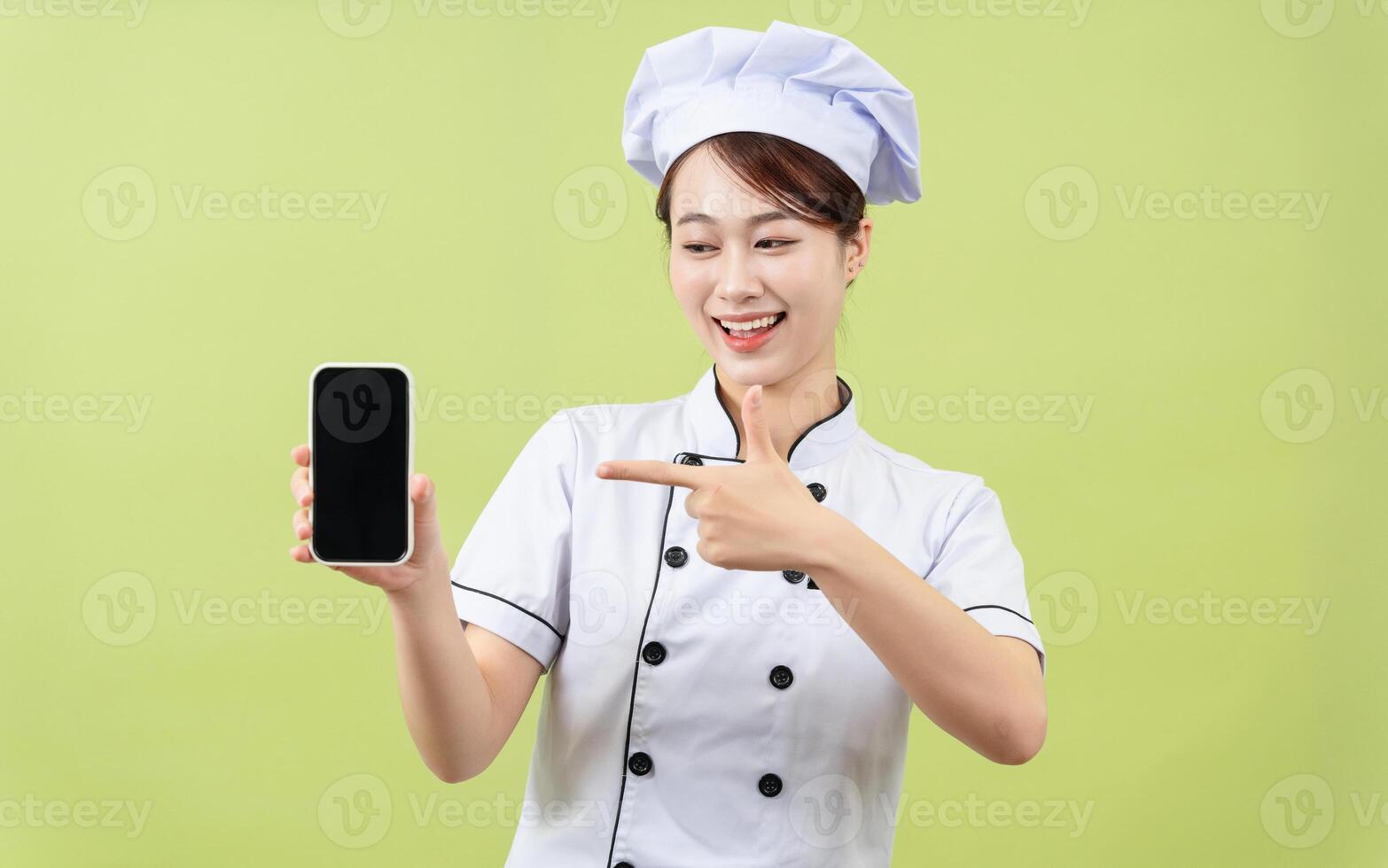 Photo of young Asian female chef on background