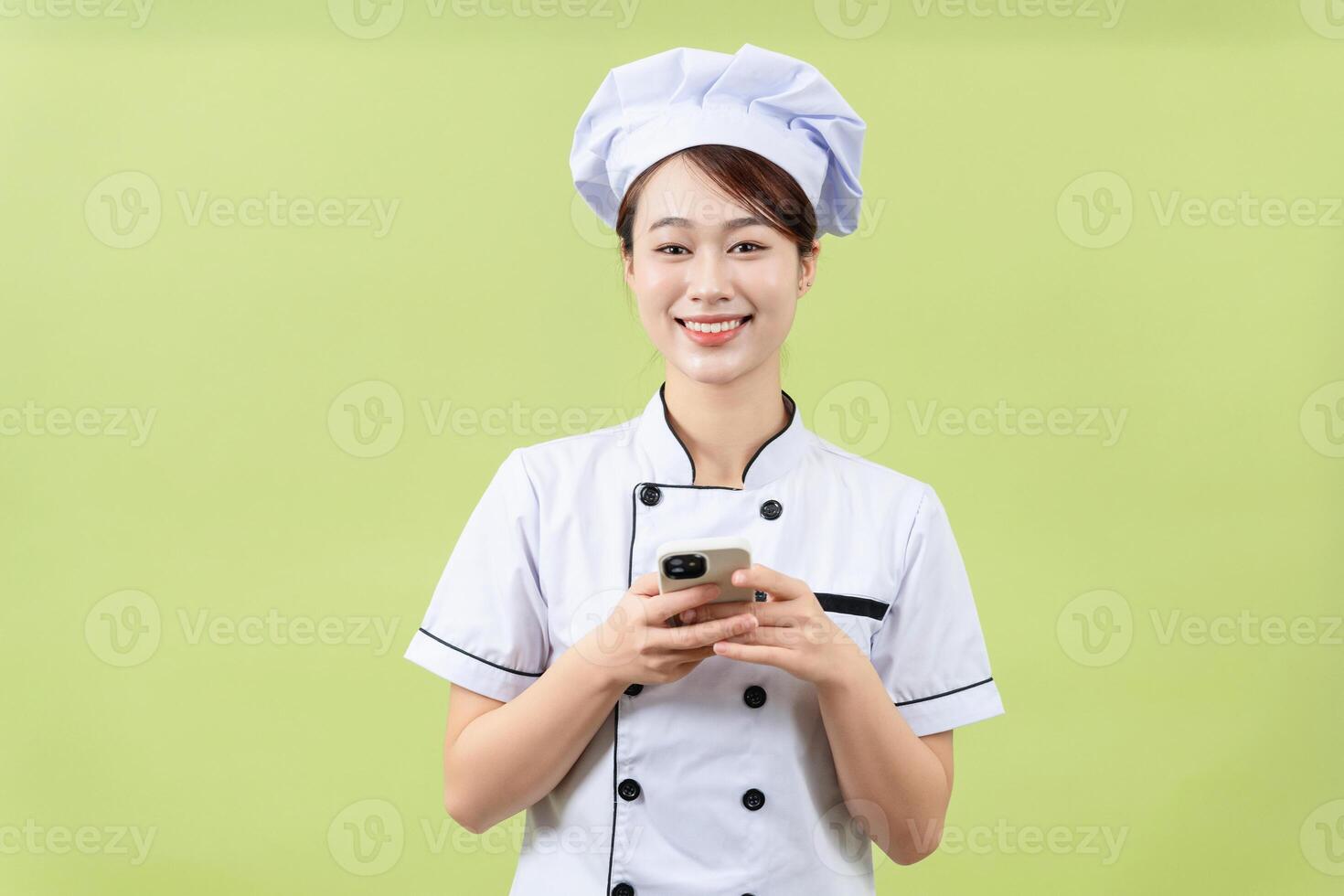 Photo of young Asian female chef on background