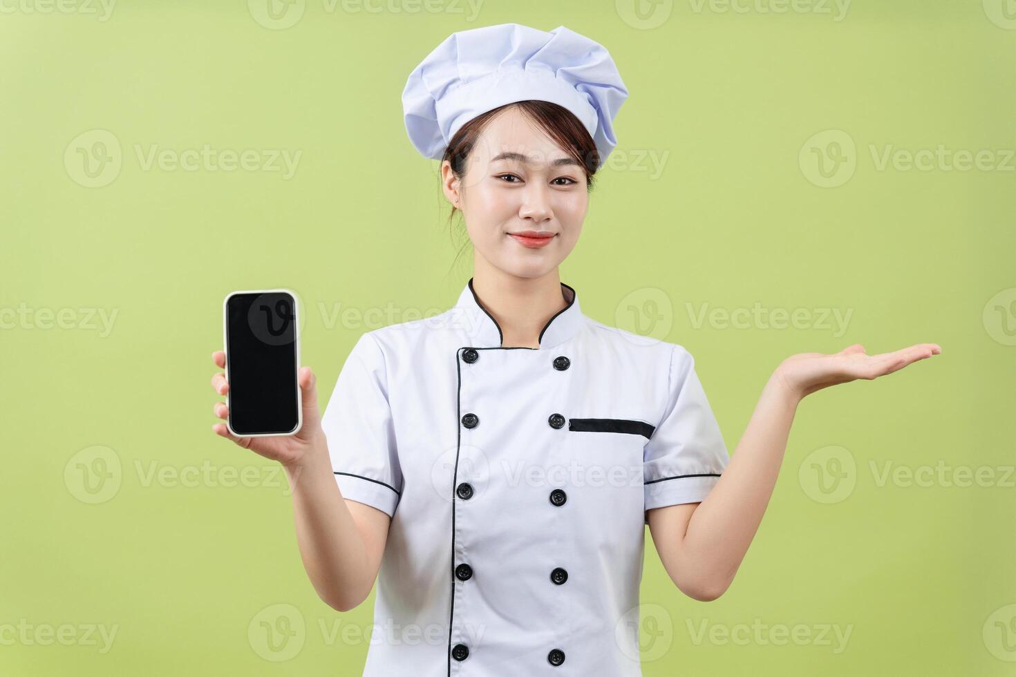 Photo of young Asian female chef on background