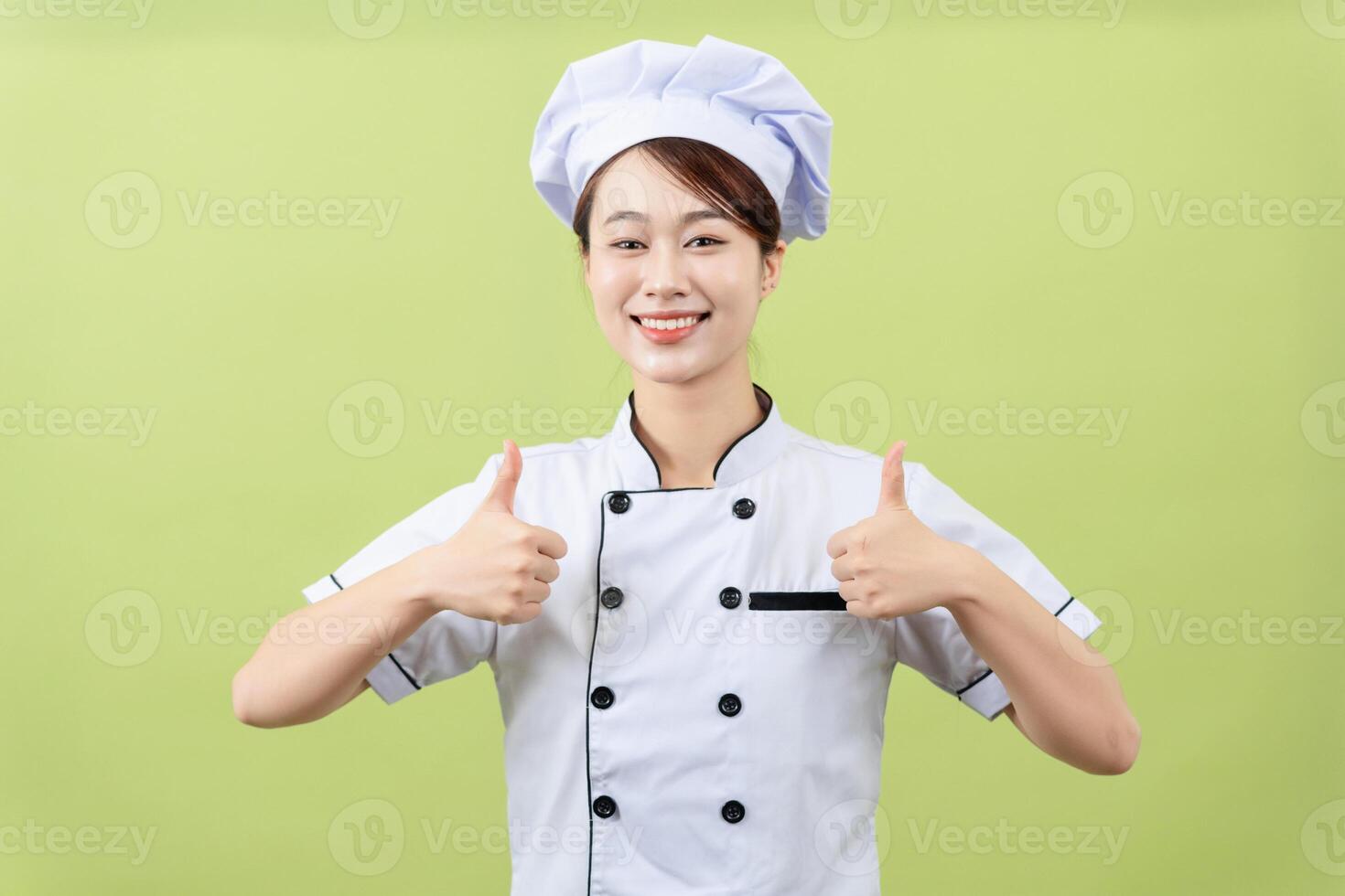 Photo of young Asian female chef on background