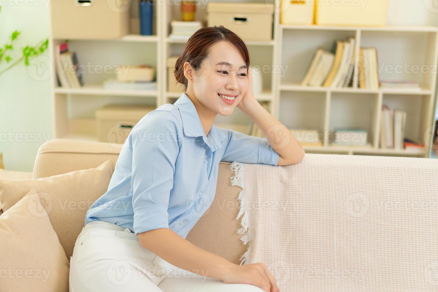 Photo of young Asian woman at home