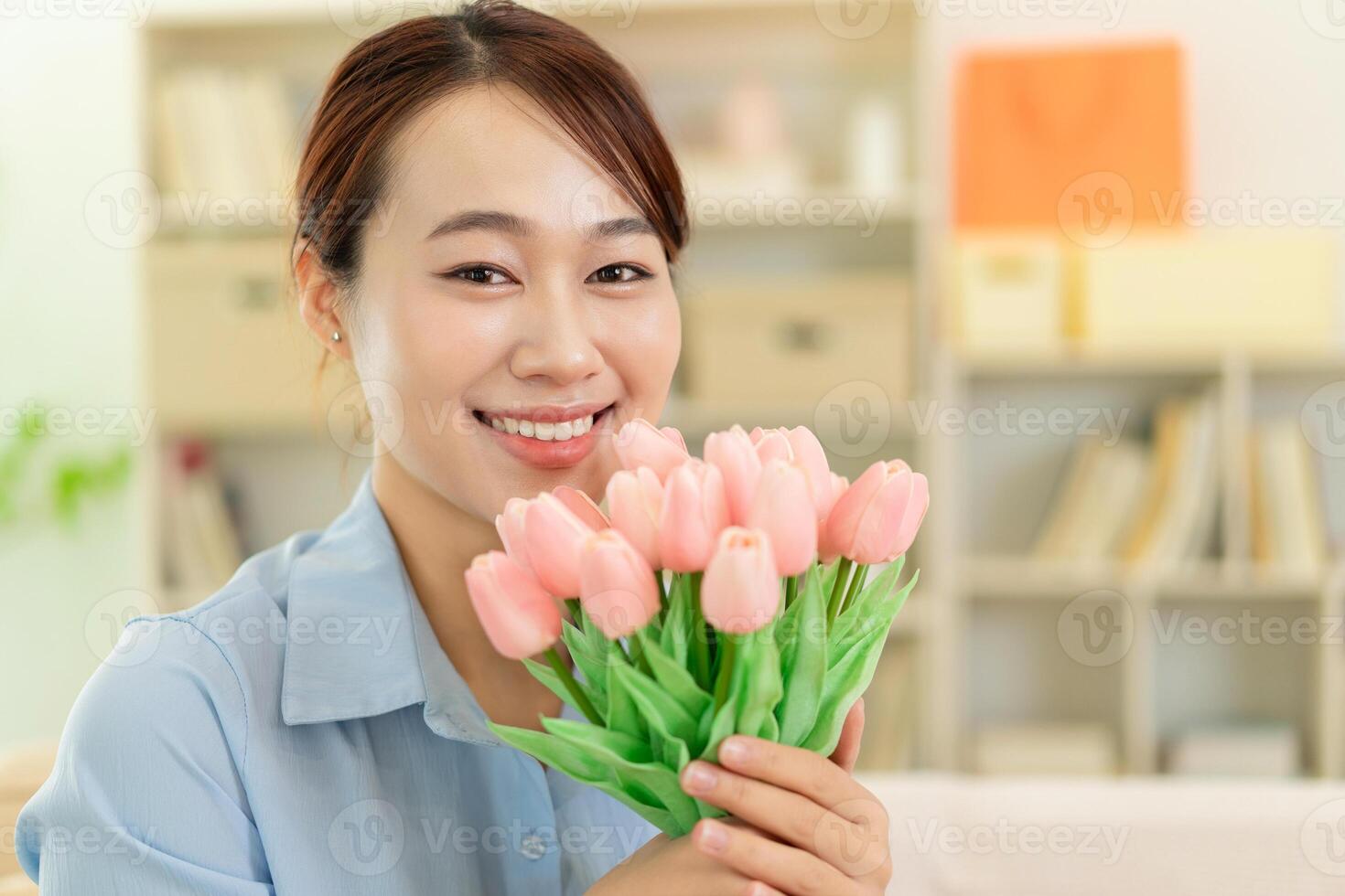 Photo of young Asian woman at home