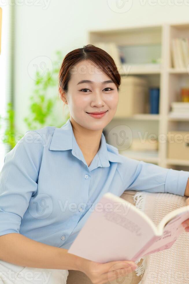 Photo of young Asian woman at home