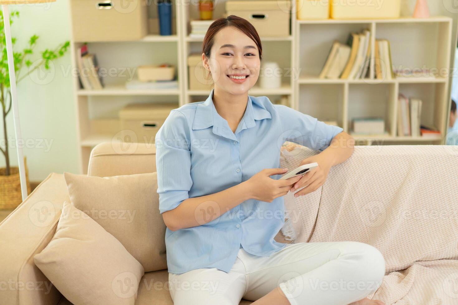 Photo of young Asian woman at home