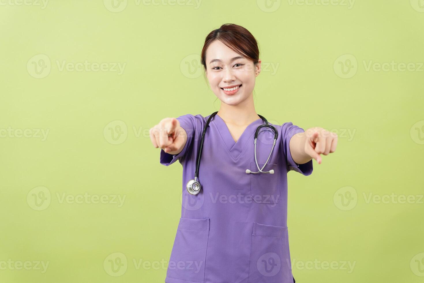Photo of young Asian femle doctor on green background