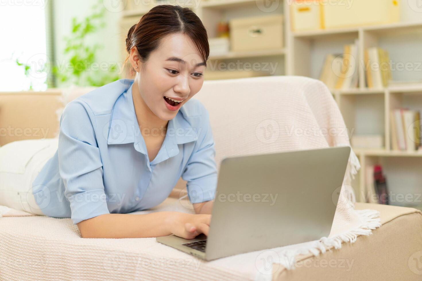 Photo of young Asian woman at home