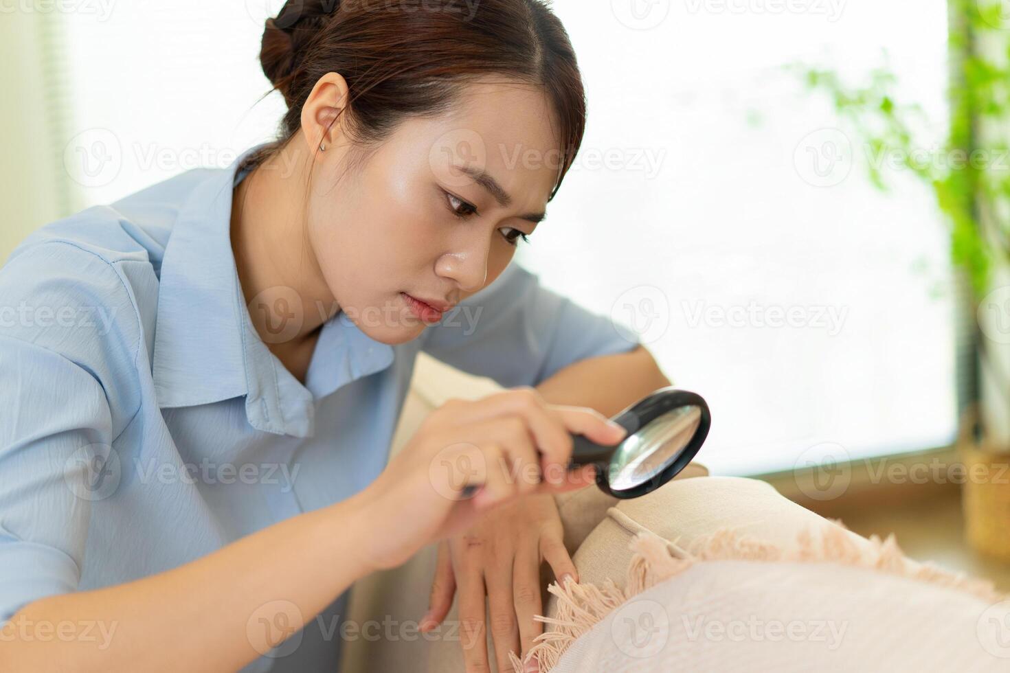 Photo of young Asian woman at home