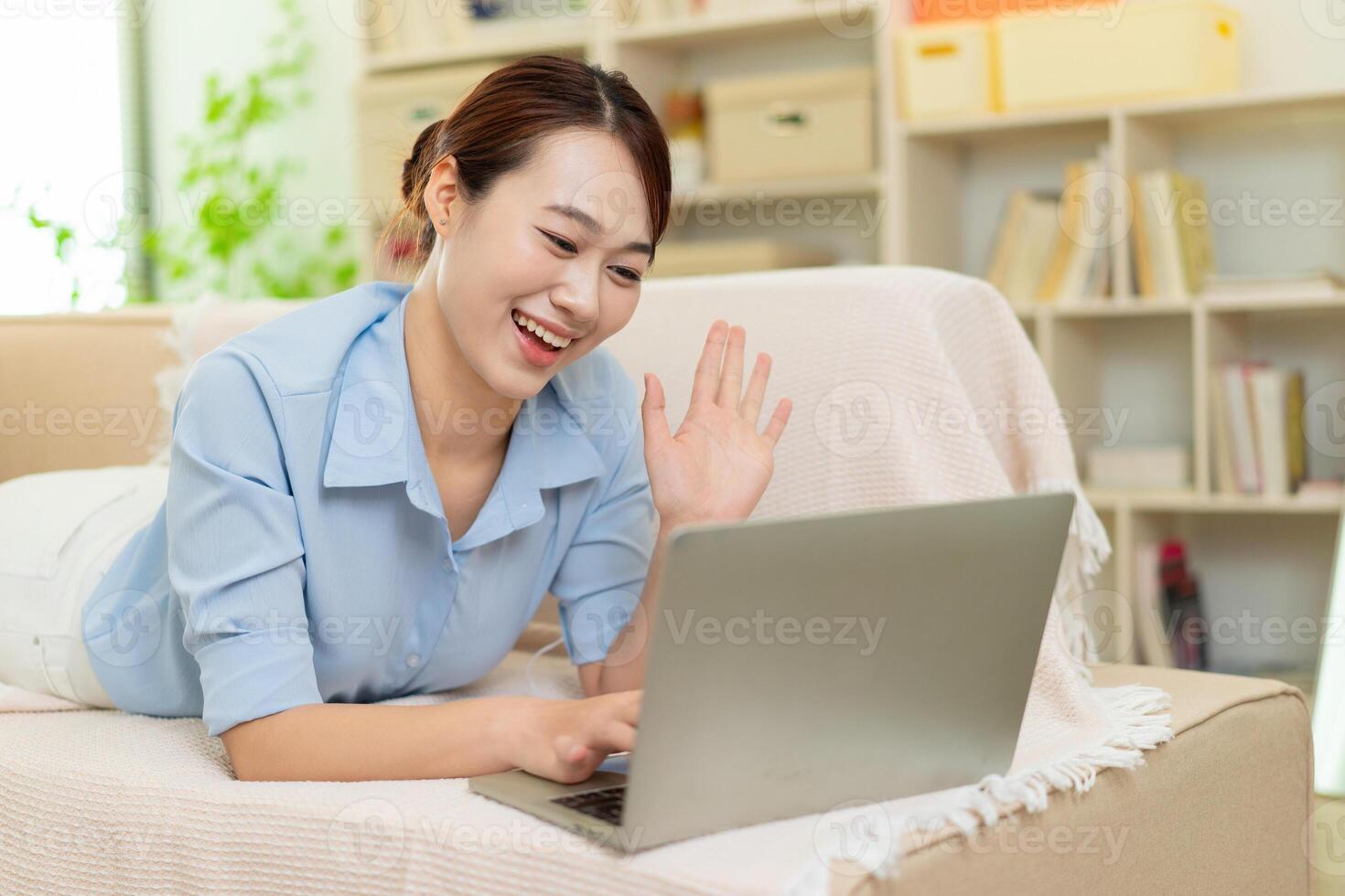 Photo of young Asian woman at home